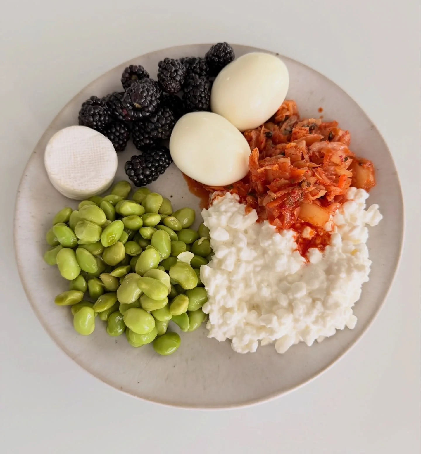 forty grams protein plate. it can be so simple &amp; still satisfying &amp; delicious!
10g: 1/2c edamame
14g: 1/2c 2% cottage cheese
12g: 2 hard boiled eggs
4g: brie bite
+ carbs, fiber, probiotics &amp; fat: 
blackberries, kimchi, eggs &amp; cottage