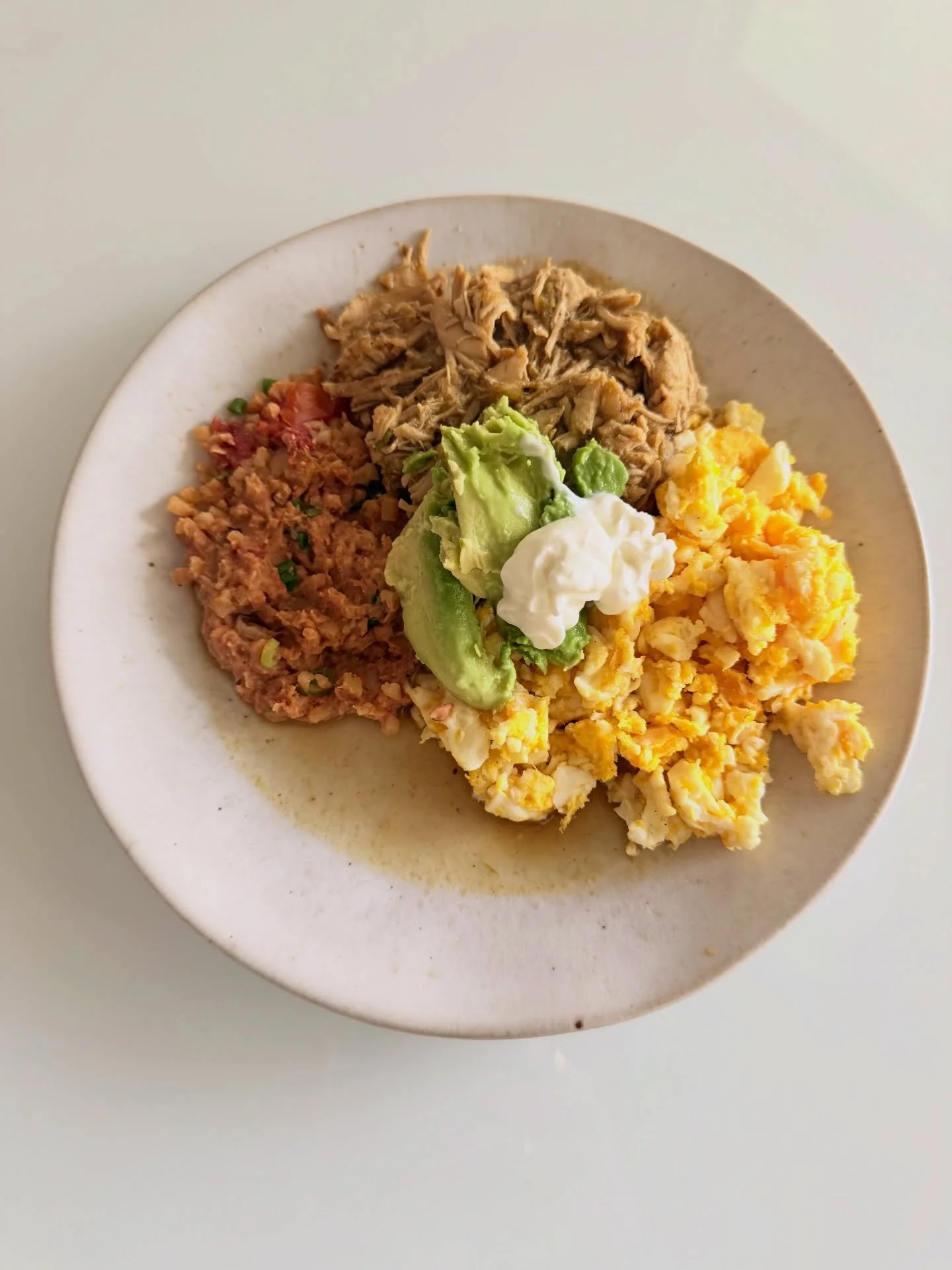 45g protein breakfast plate
2 scrambled eggs
3/4c leftover shredded green enchilada sauce chicken (see chicken highlight)
leftover spanish cauli rice + refried beans (see sides highlight)
top with a slice of avocado &amp; light sour cream