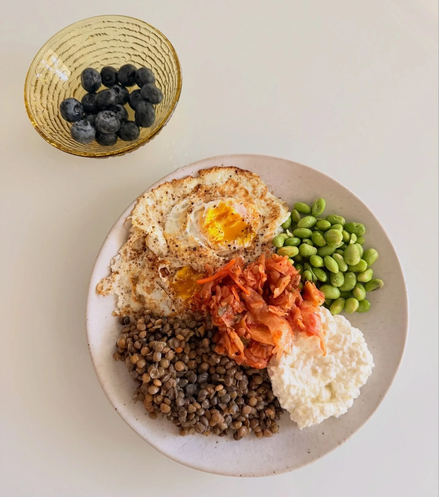 35g of protein perfection if you ask me!!
1/4c 2% cottage cheese: 7g
1/2c cooked lentils @traderjoes: 10g
2 eggs: 12g
1/3c edamame: 6g
+my favorite @clevelandkitchen kimchi &amp; jumbo blueberries