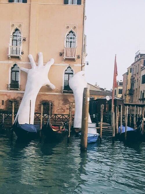 Giant hand sculpture by Lorenzo Quinn in Venice