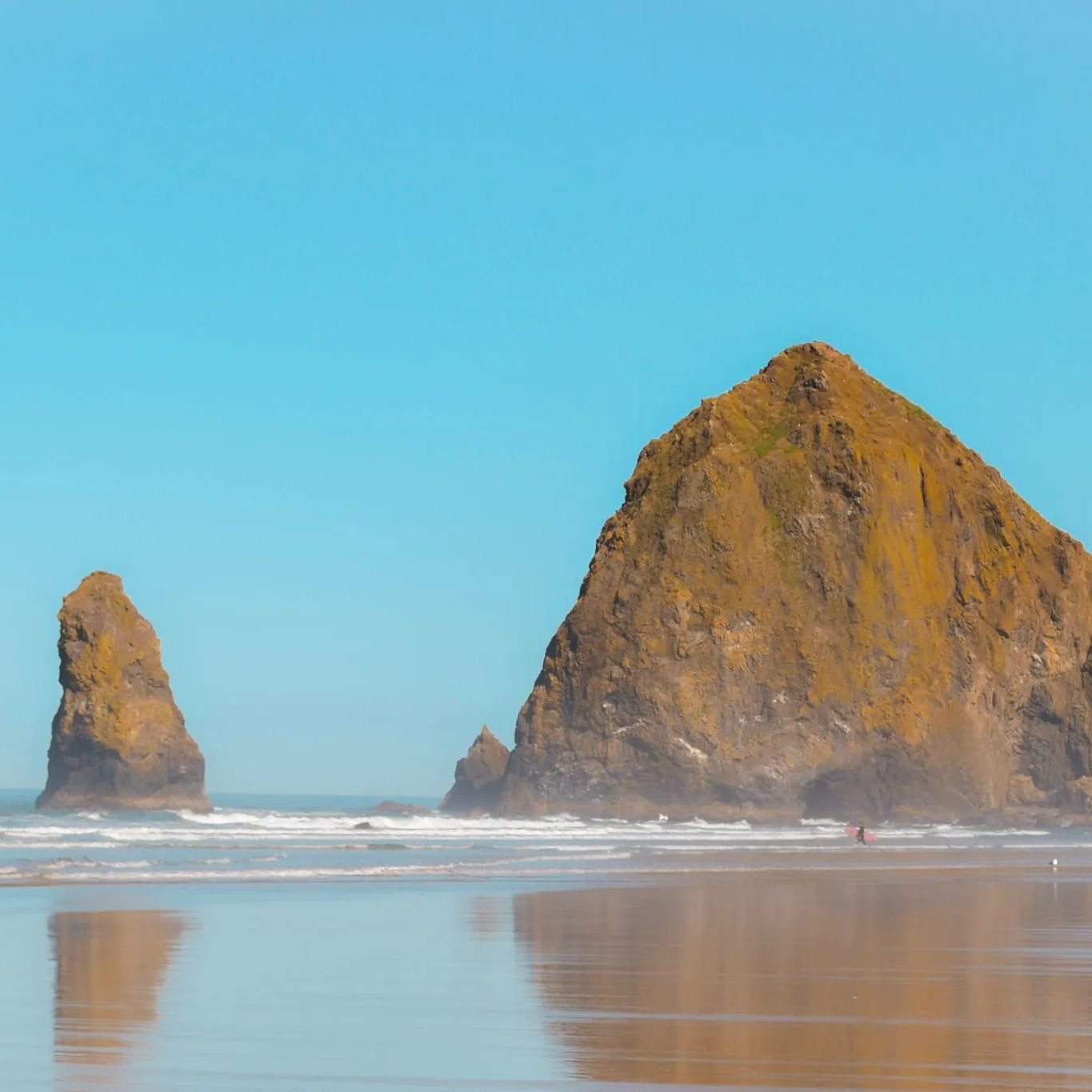 Haystack Rock&mdash;ever heard of it? 🪨 
 
This towering sentinel is just one of the wonders waiting for you at Cannon Beach. But this enchanting spot on the Oregon coast is more than just a photo opp. It's a playground for the adventurous and a hav