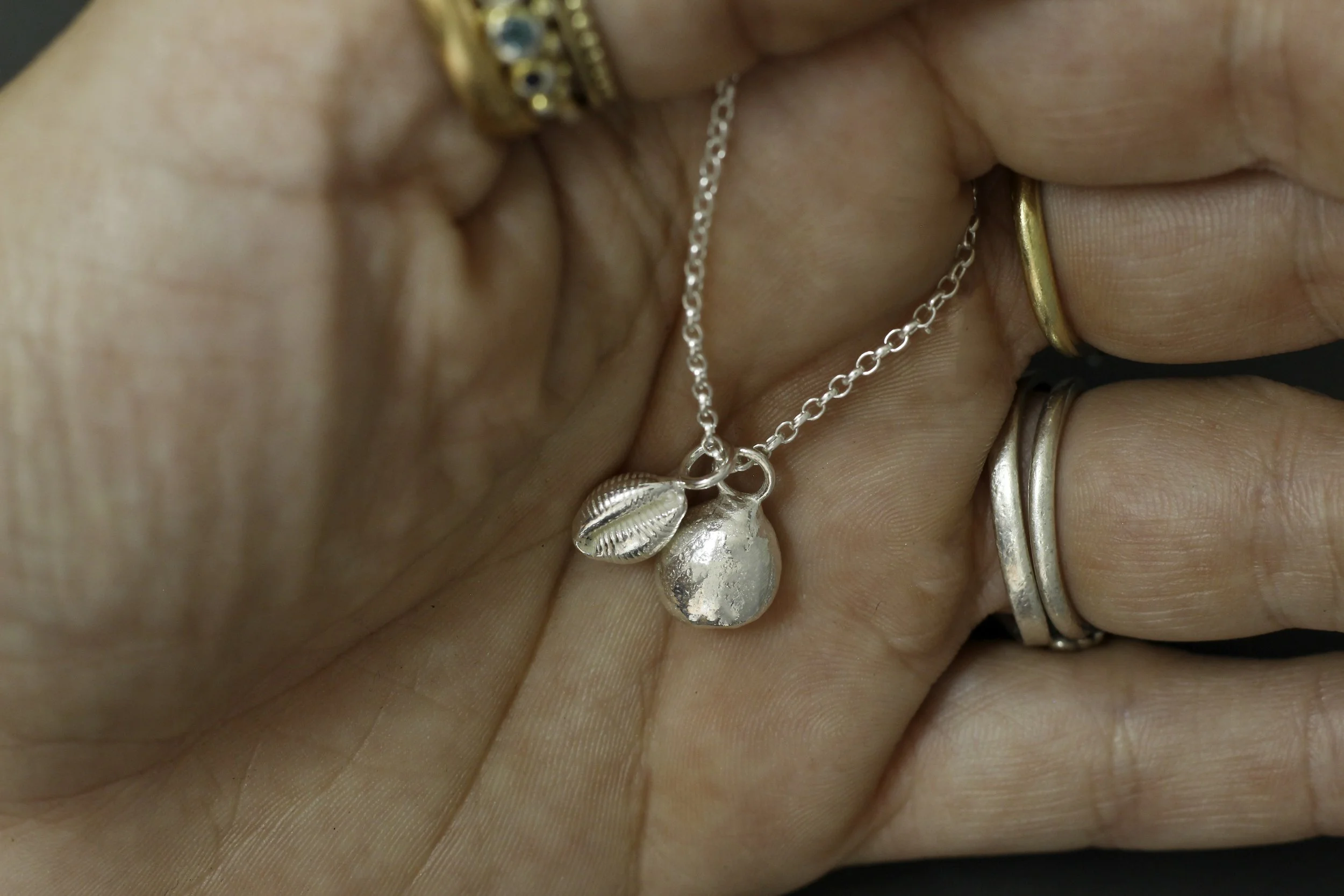 300-hand-cowrie and peb.jpg