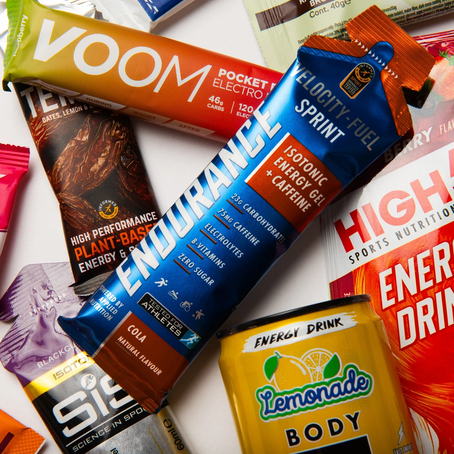 Contents of an Athlete Box laid out: gels, chews, bars and electrolyte tabs