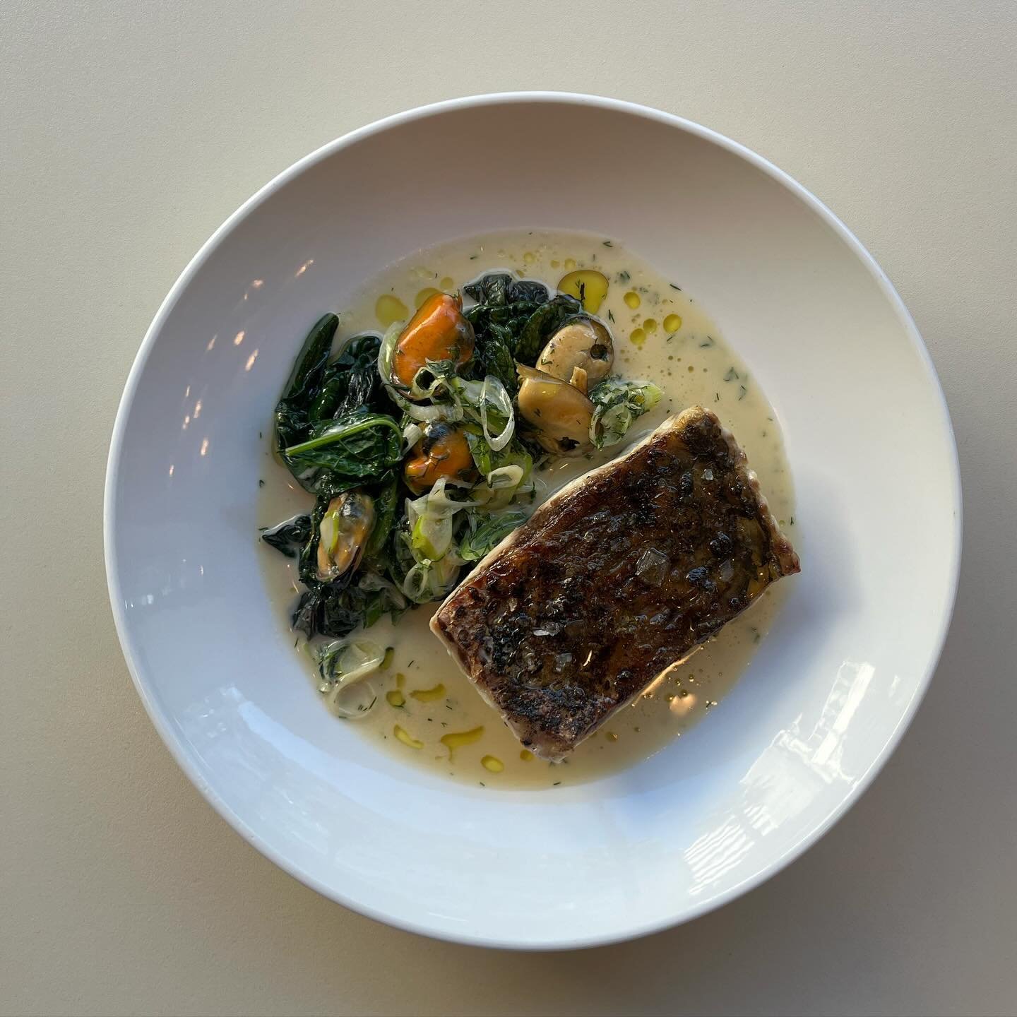 New&rsquo;ish in the menu. Crispy skinned sea bass , cooked over the coals sitting alongside charred mustard leaves and dashi steamed mussels in a dill spiked mussel sauce.