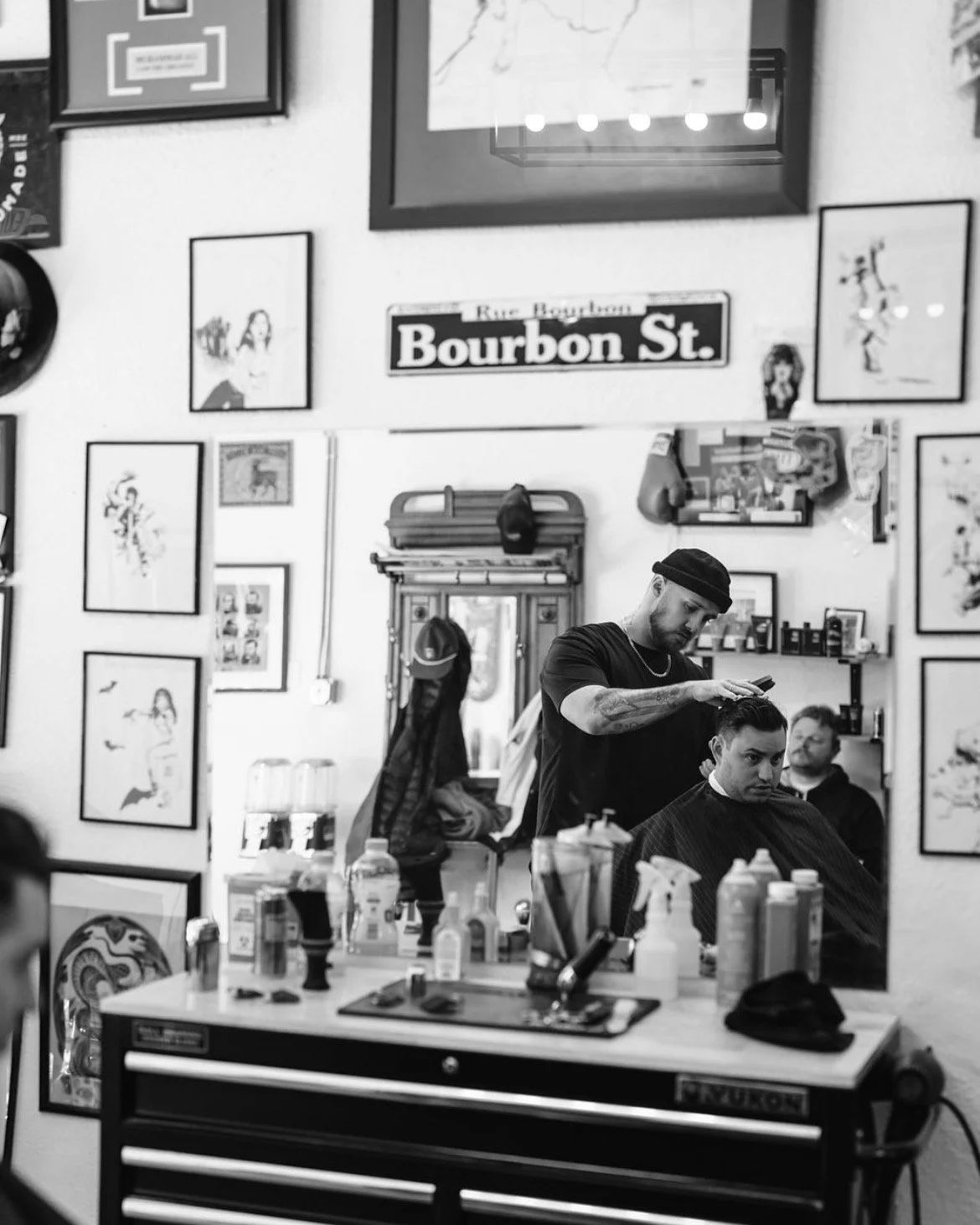 The reflection of Tony cutting someone's hair in the mirror.