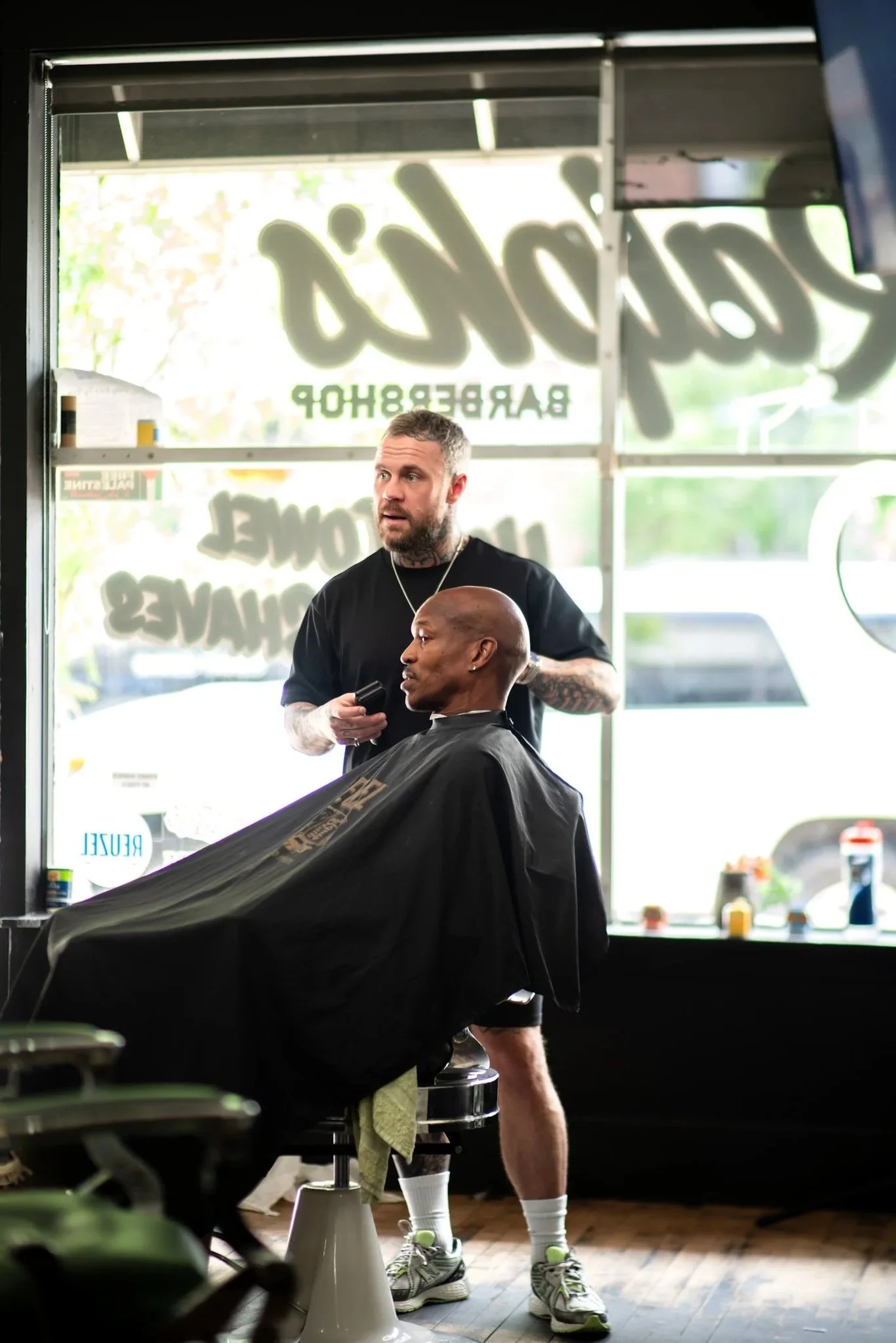 Ralph cutting a customer's hair.