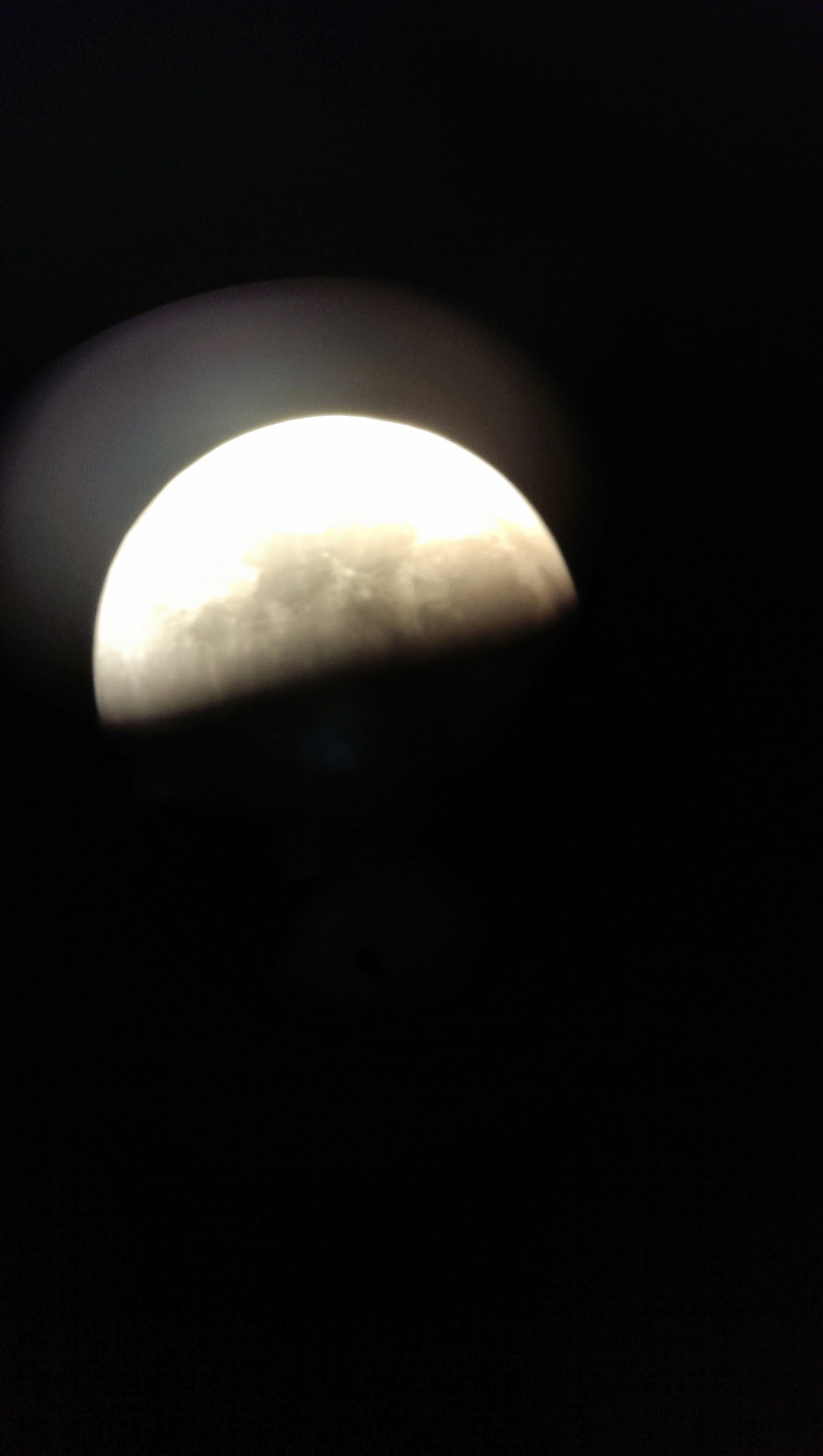  Image of the moon taken with a cell phone held up to a telescope 