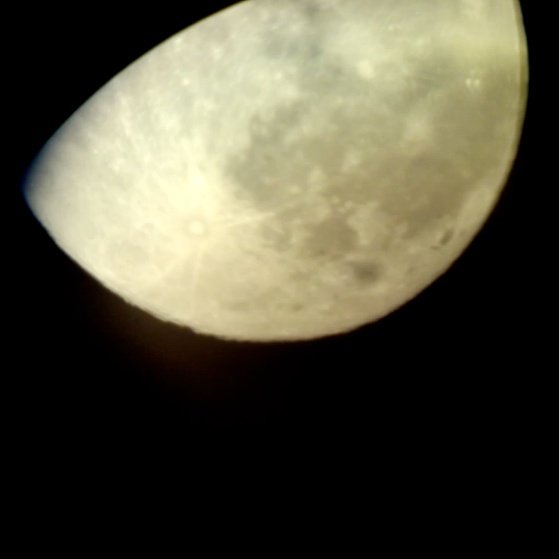  Image of the moon taken with a cell phone held up to a telescope 