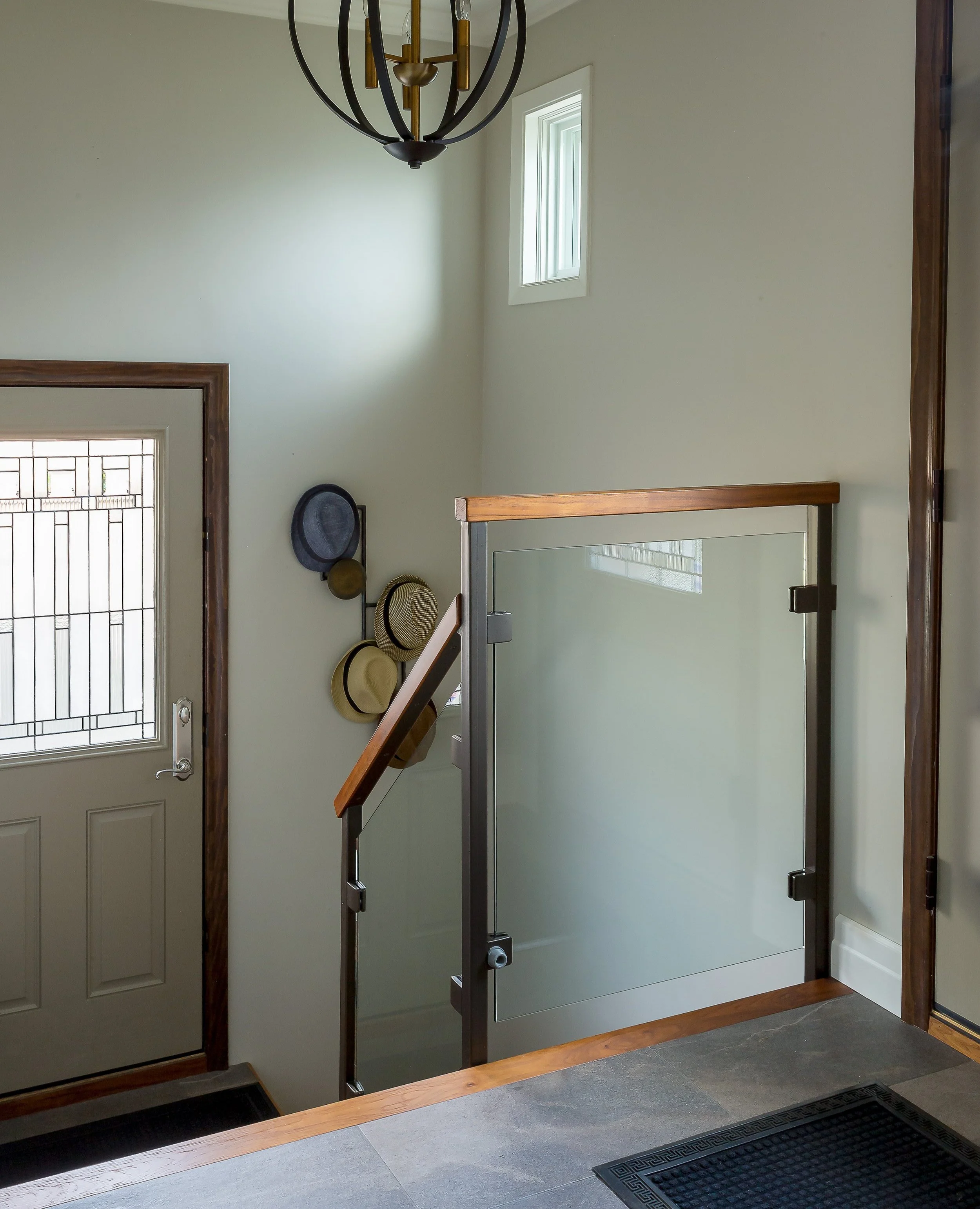 Wall mounted coat rack in an entranceway designed by Yassein Interiors.