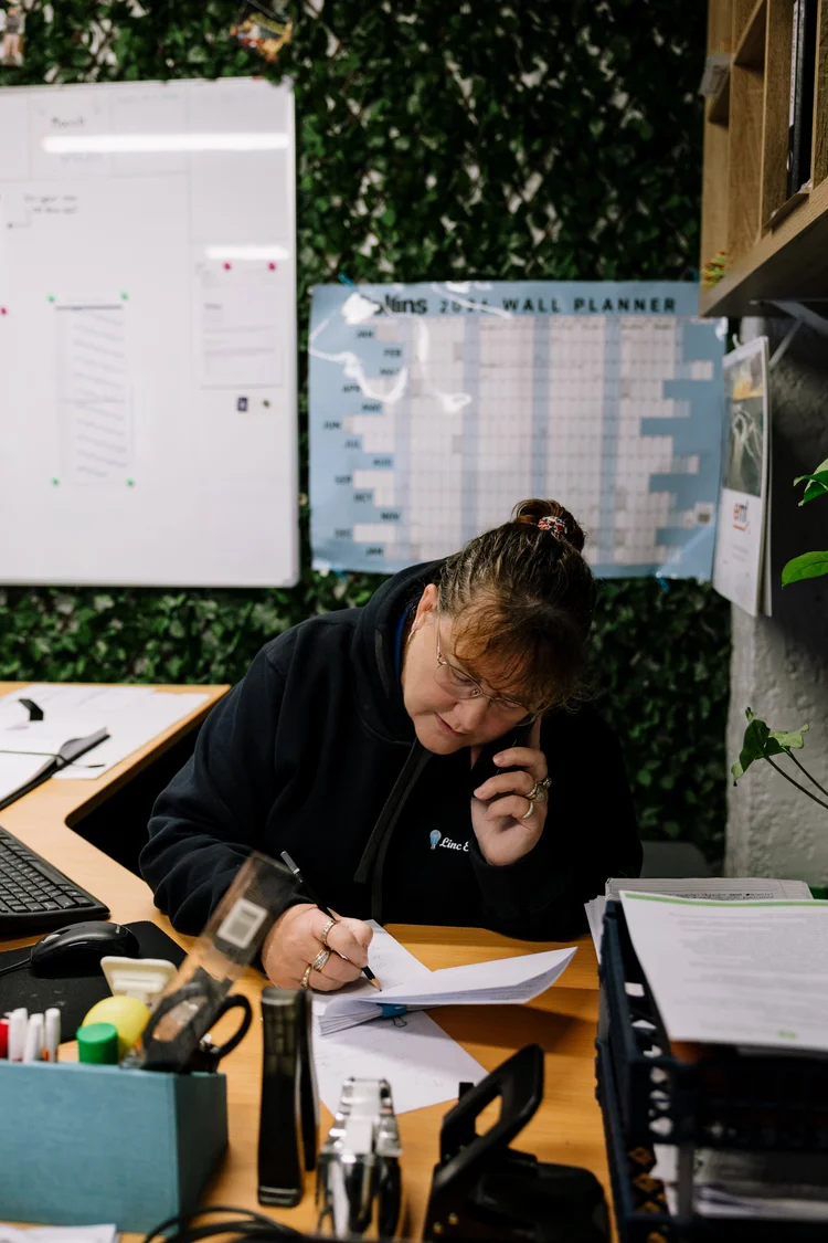 Linc Electrical office staff on the phone booking a time with a tenant