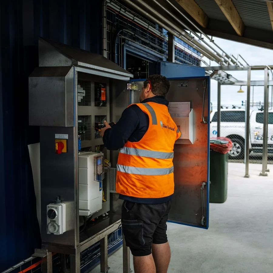Electrician wiring a static var generator cabinet