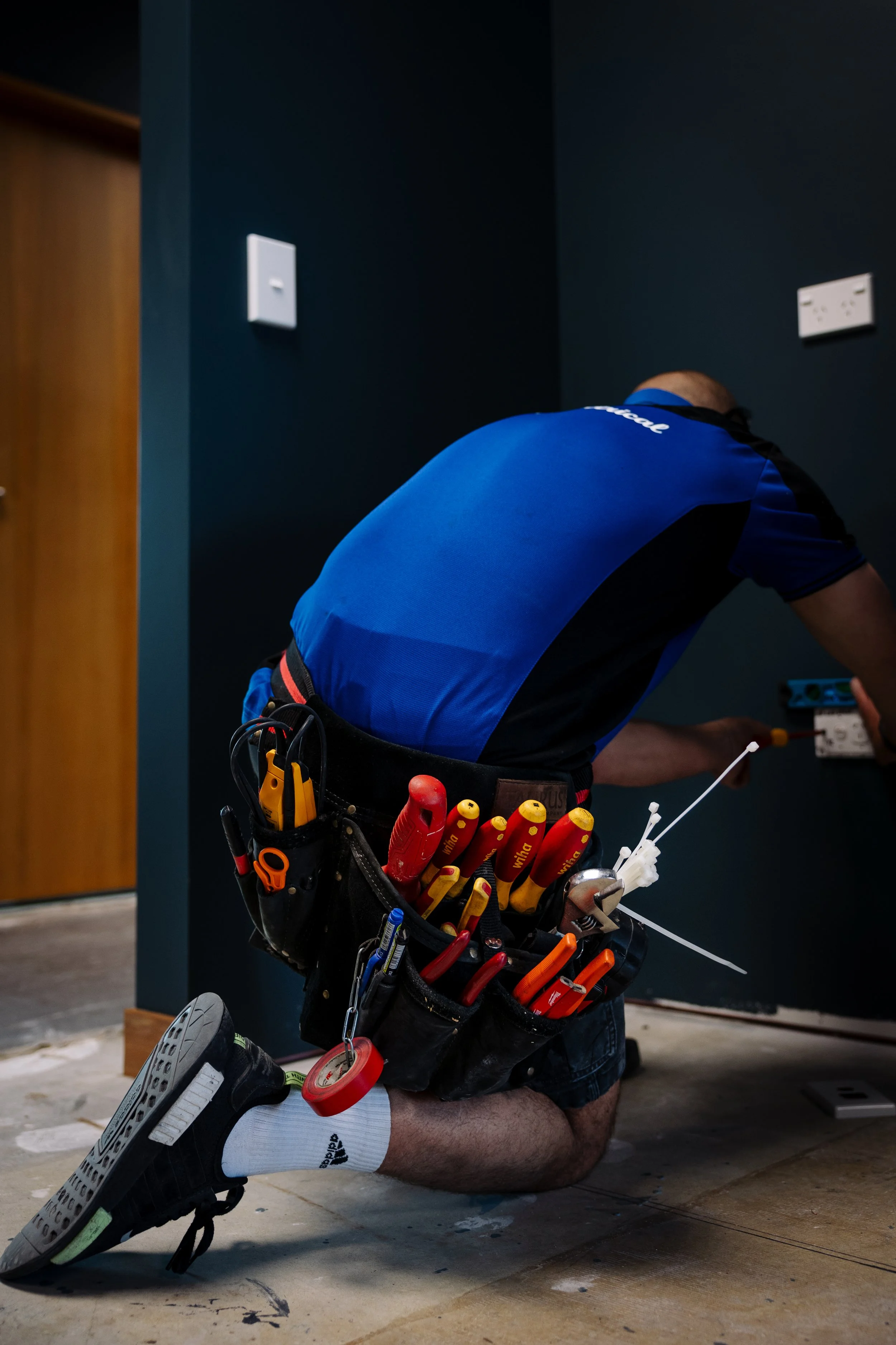Two electricians from Linc Electrical are working on an outdoor electrical installation