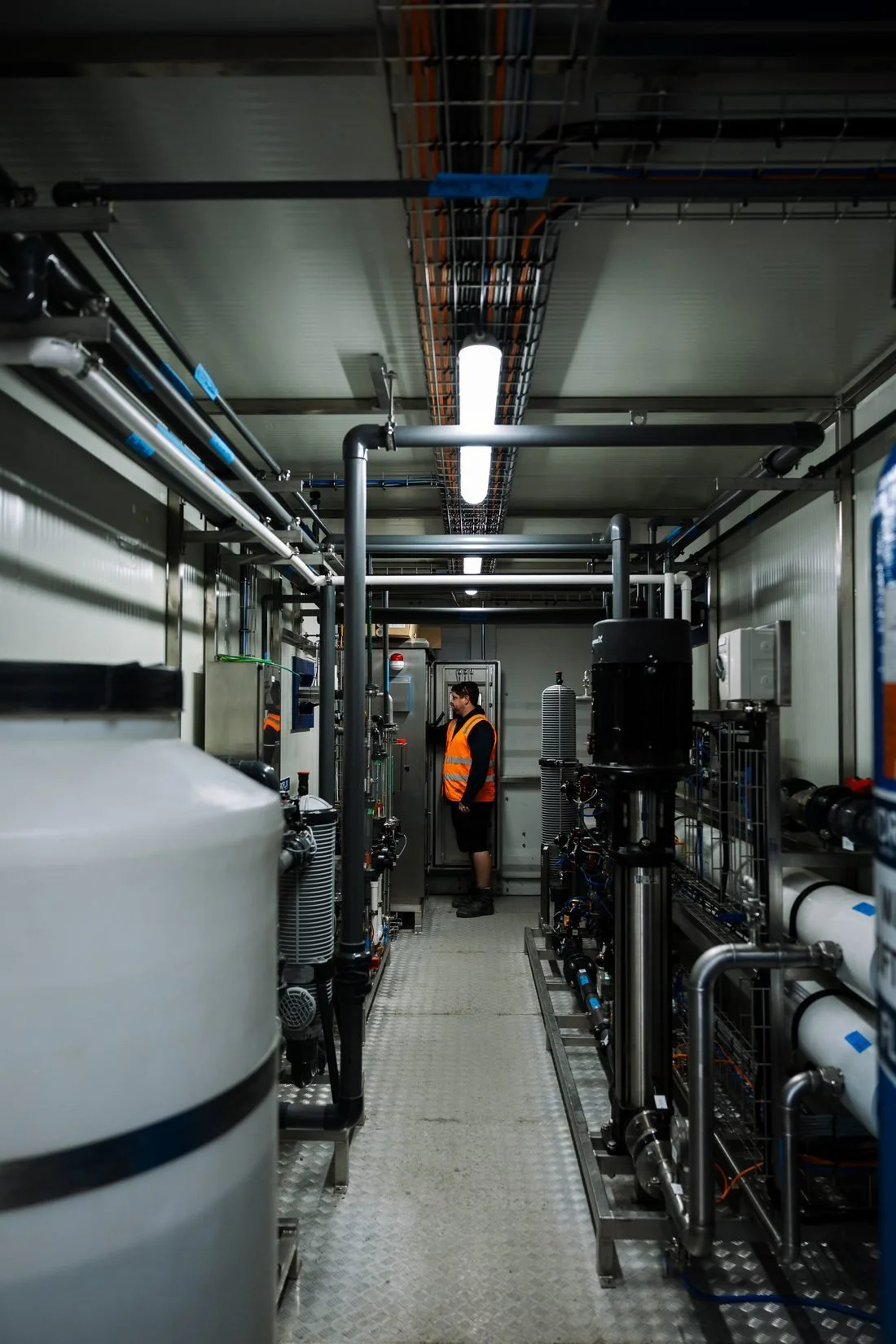 Industrial plant room with pipework and cable tray, Manawatū processing site