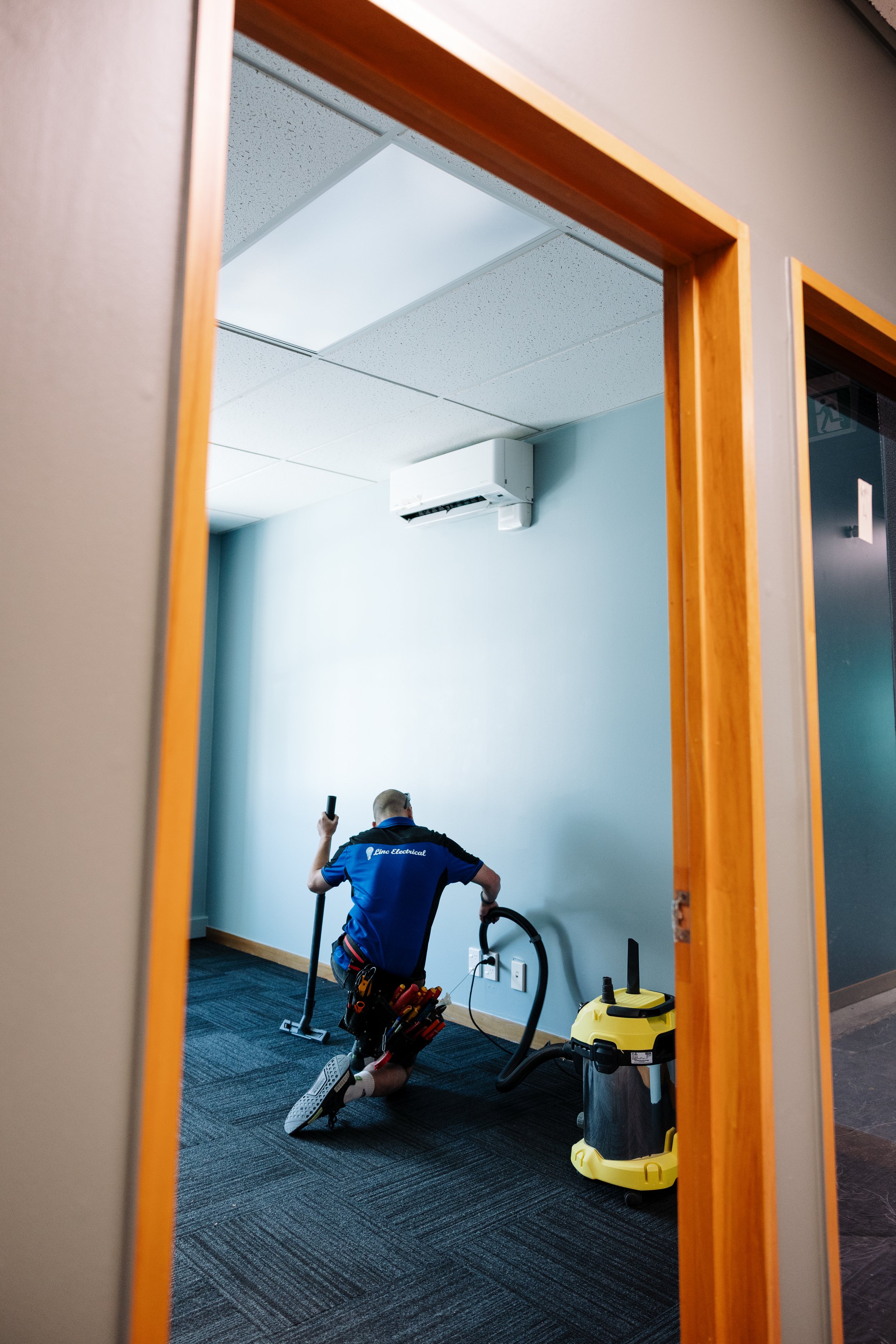 Linc Electrical electrician cleaning up after a commercial fitout