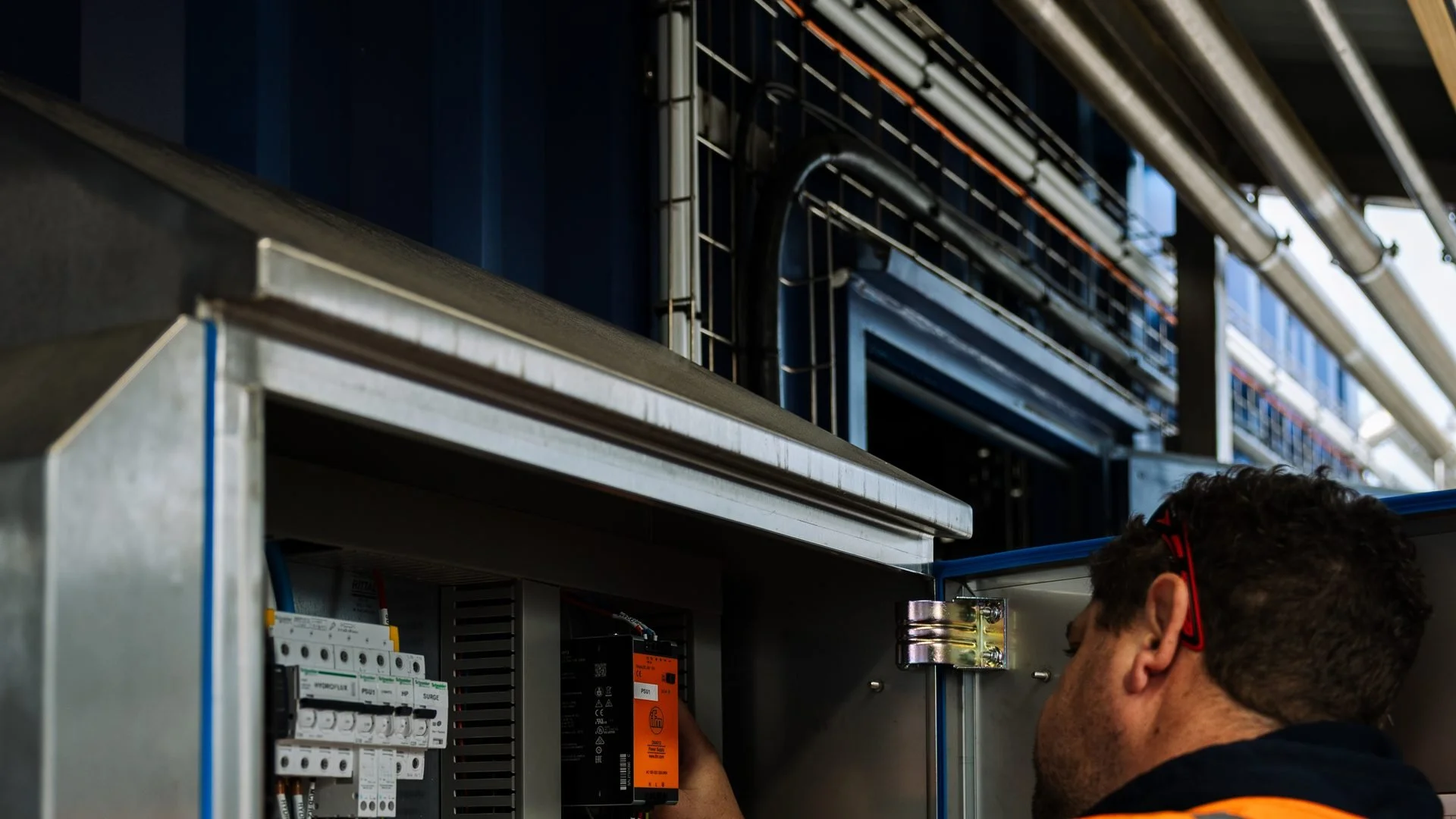 Industrial electrician working on a switchboard at a processing plant in Palmerston North