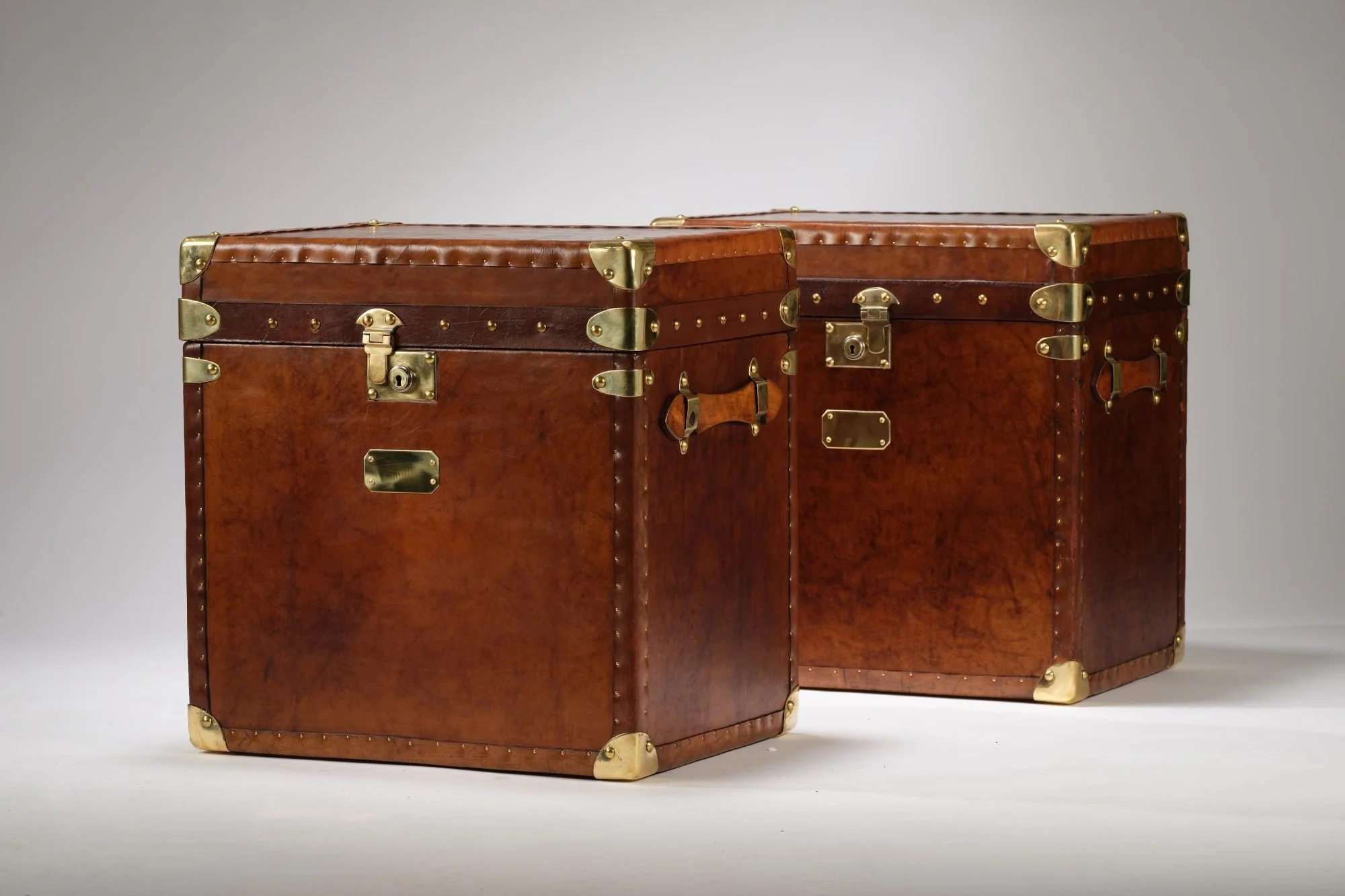 Gorgeous matching pair of vintage english saddle leather trunks perfect for side or bedside tables or even a coffee table.