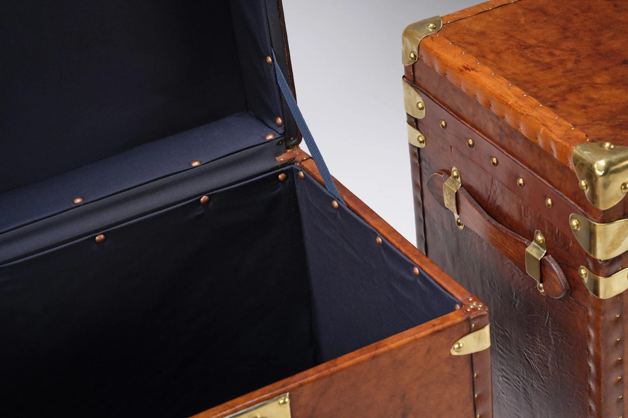 Gorgeous matching pair of vintage english saddle leather trunks perfect for side or bedside tables or even a coffee table.