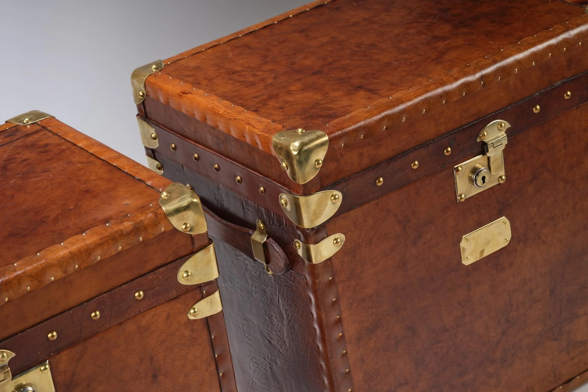 Gorgeous matching pair of vintage english saddle leather trunks perfect for side or bedside tables or even a coffee table.
