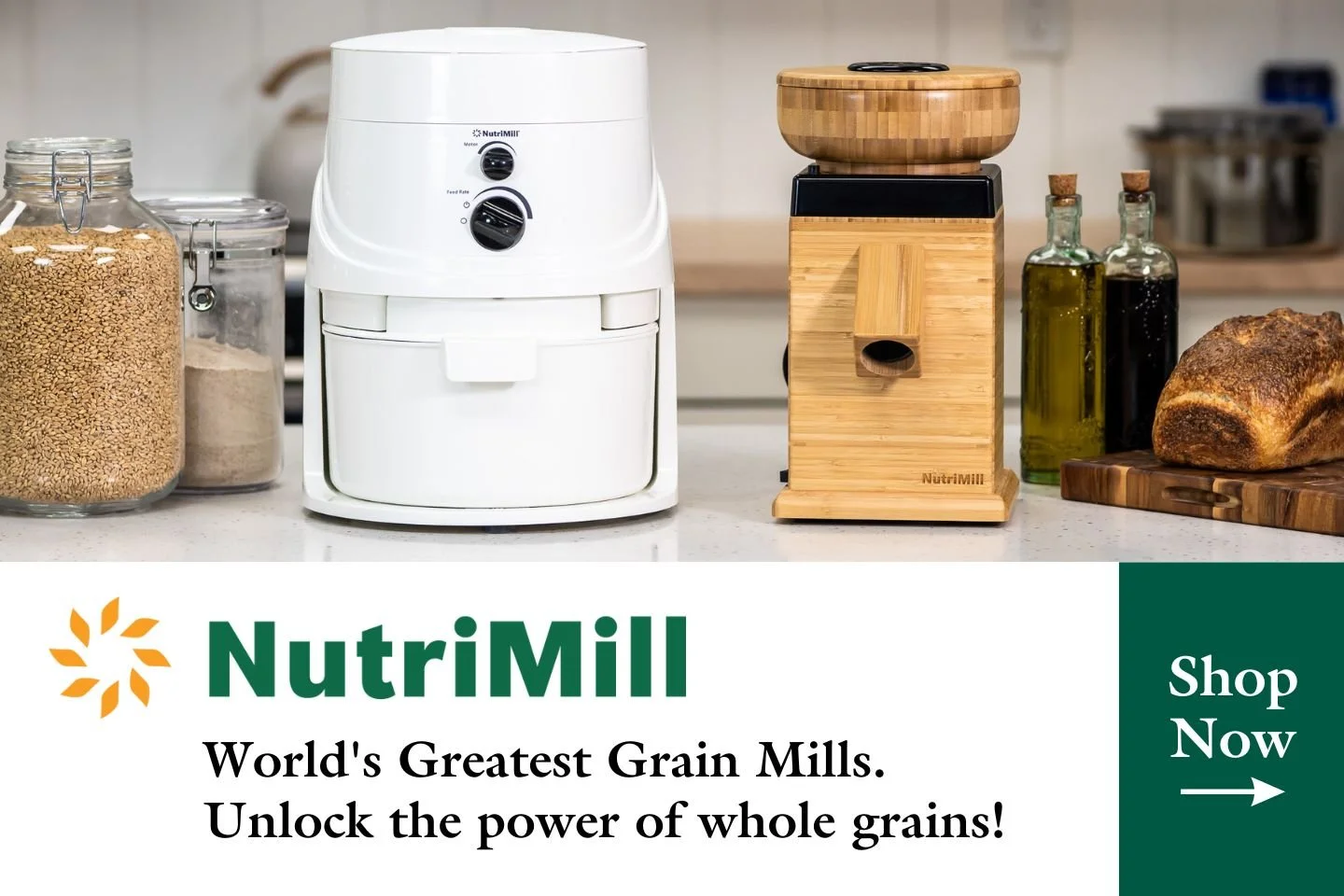 Kitchen countertop with grain mills, jars of grains, and a loaf of bread, advertising NutriMill grain mills.