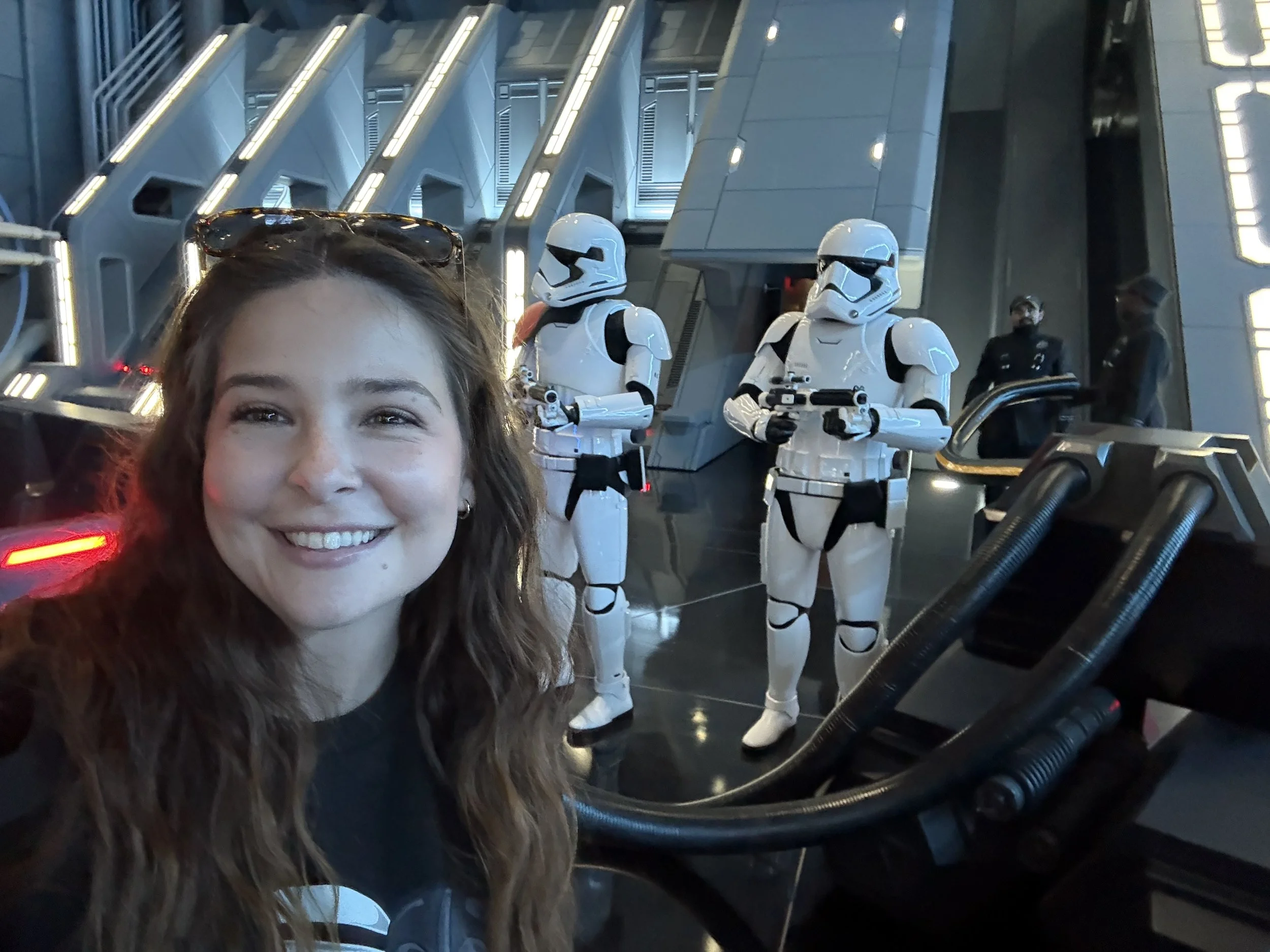 A woman smiling in front of two stormtroopers in Galaxy's Edge, Hollywood Studios.
