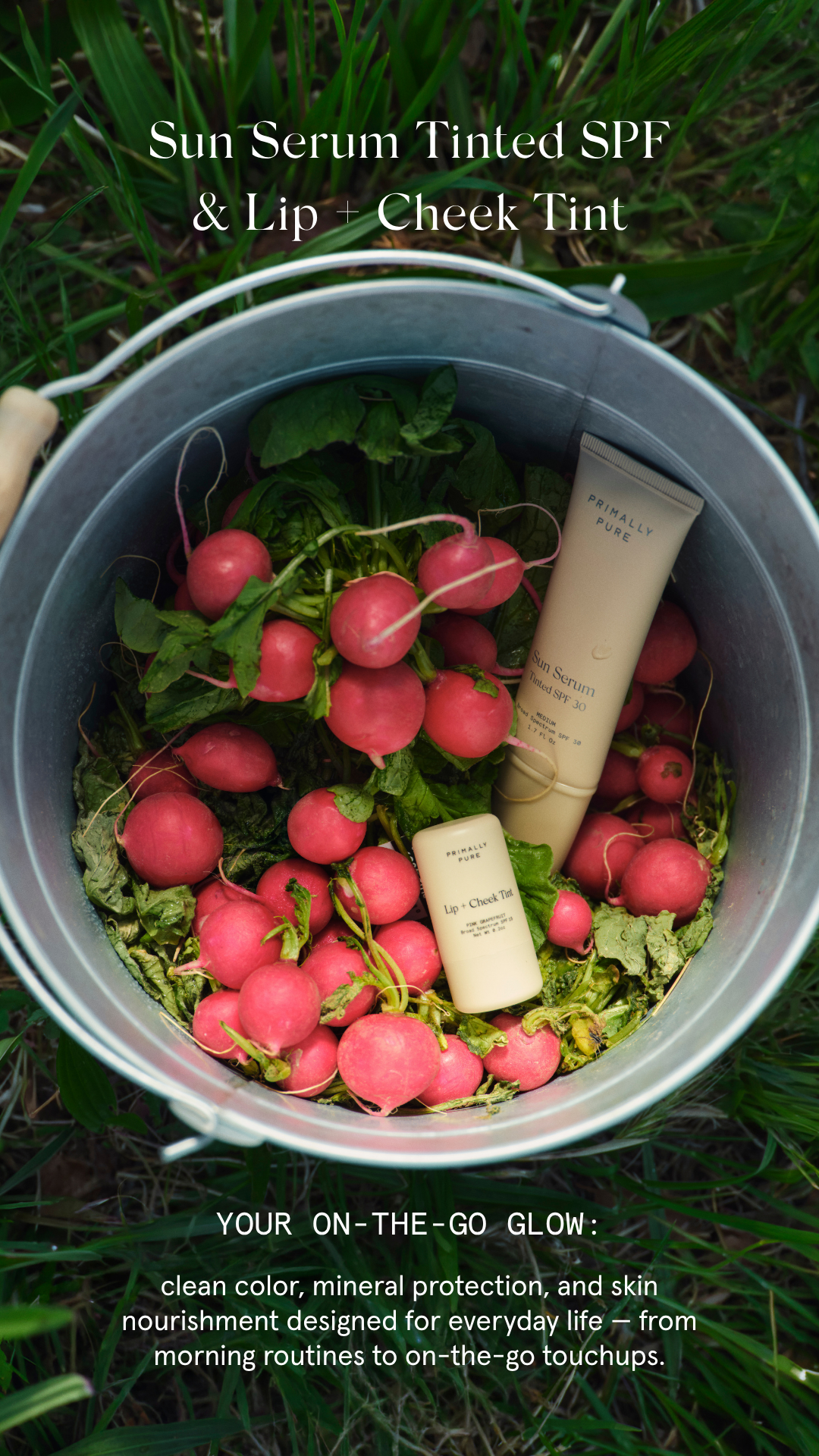 A bucket filled with radishes and two skincare products labeled 'Primally Pure Sun Serum Tinted SPF 30' and 'Lip + Cheek Tint,' resting among green grass. Text overlay reads 'Sun Serum Tinted SPF & Lip + Cheek Tint. Your on-the-go glow: clean color, mineral protection, and skin nourishment designed for everyday life—from morning routines to on-the-go touchups.'
