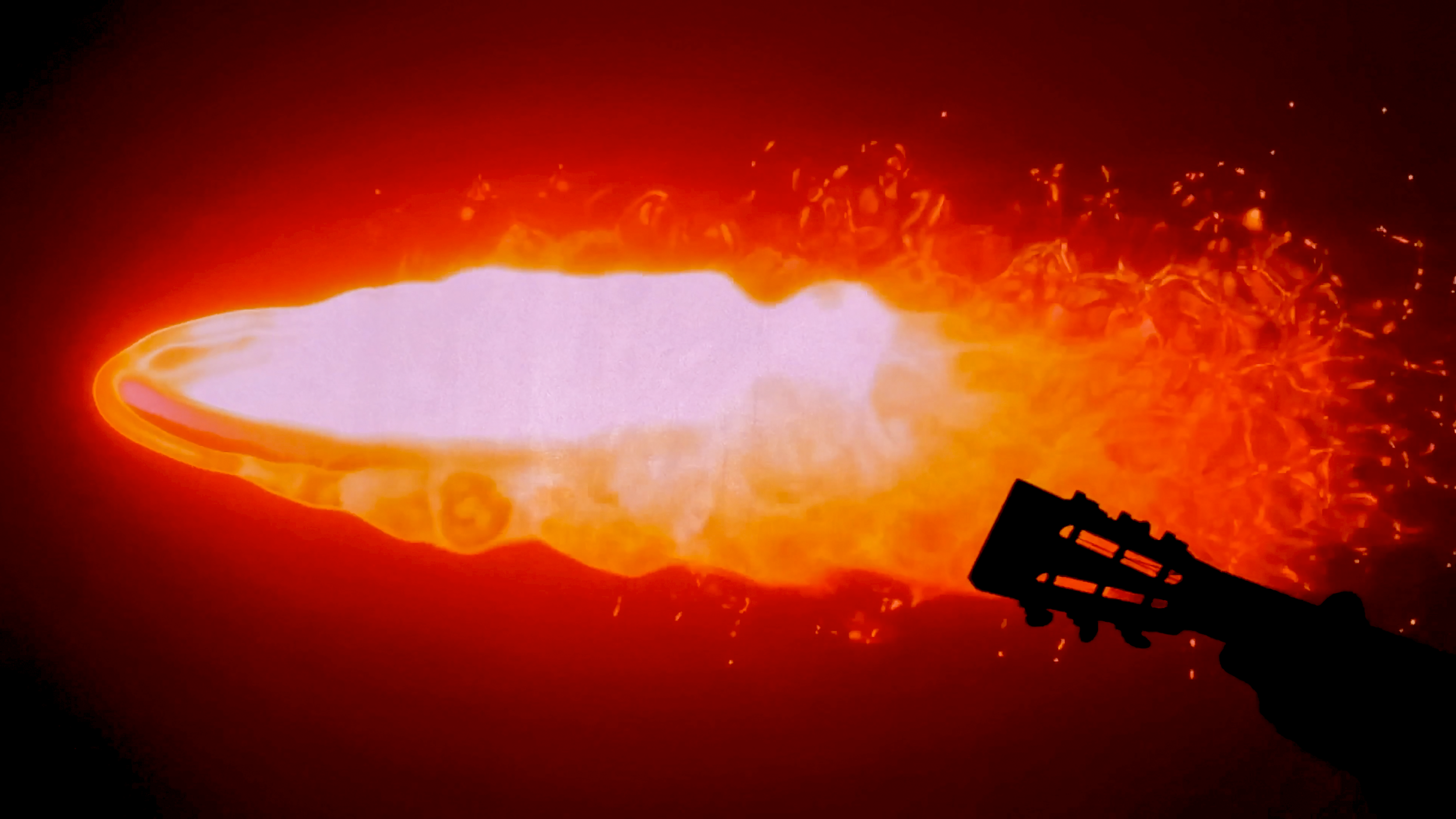 A fiery explosion with bright orange and white flames and sparks, with a dark silhouette of a cannon in the lower right corner.