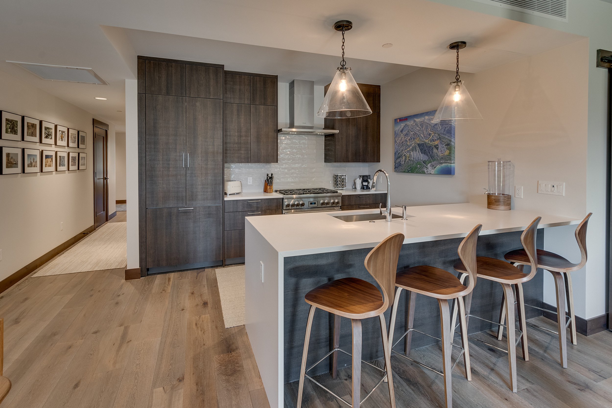 A well-designed kitchen showcasing comfortable bar stools and a sizable island, providing ample space for cooking and gathering.