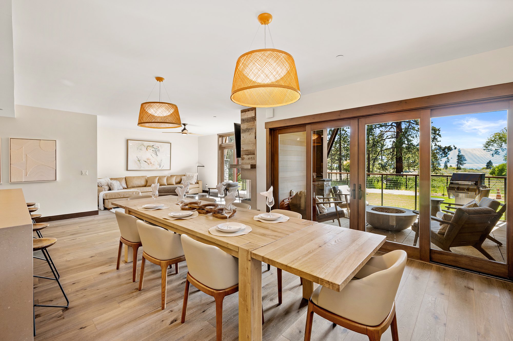 Tahoe Beach Club vacation rentals feature a well-furnished dining room with a big table and chairs. Glass doors open up to an outdoor patio with views of Lake Tahoe. 