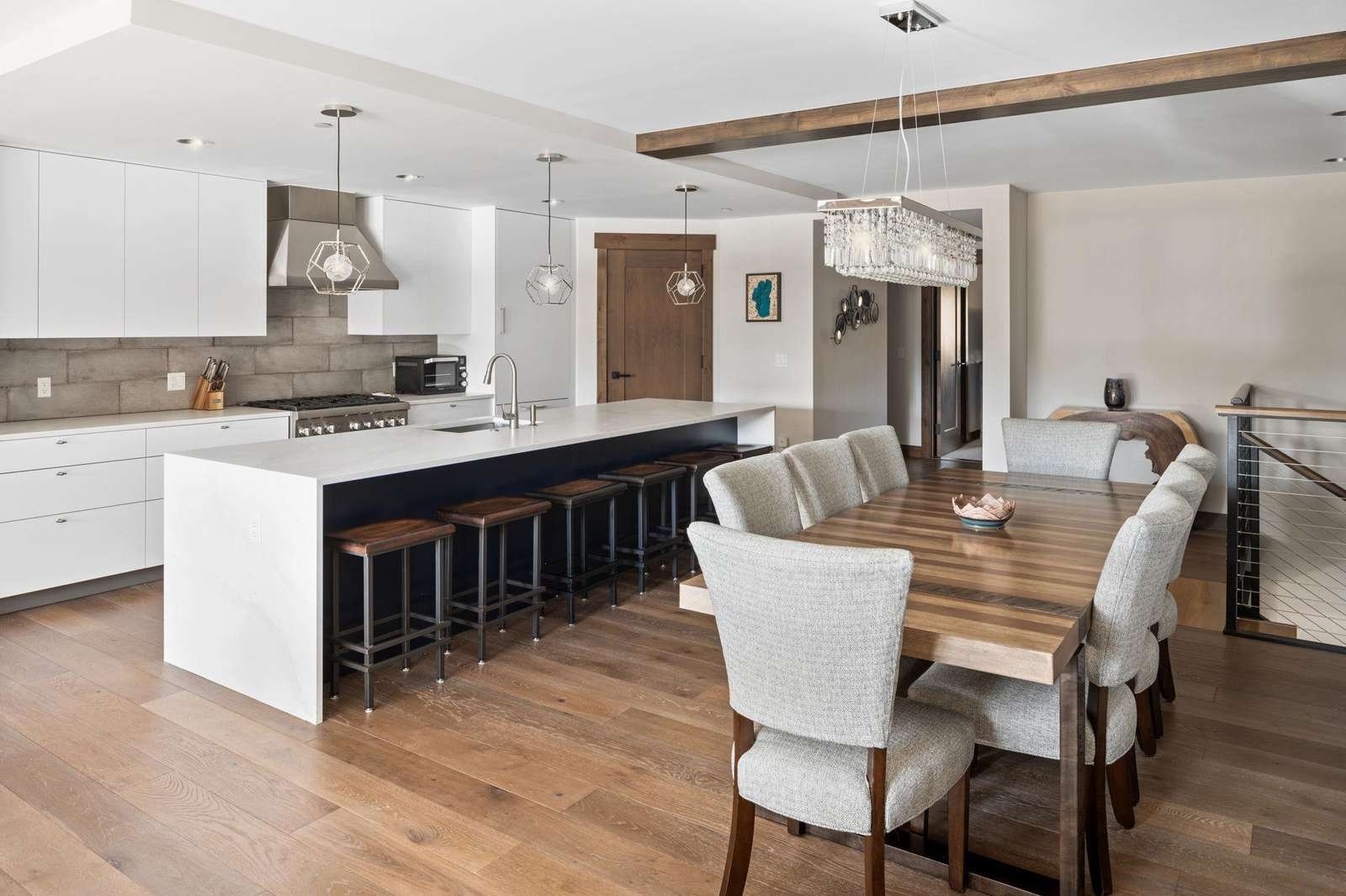 Modern kitchen and dining area featuring a large island, ideal for cooking and gathering with family.