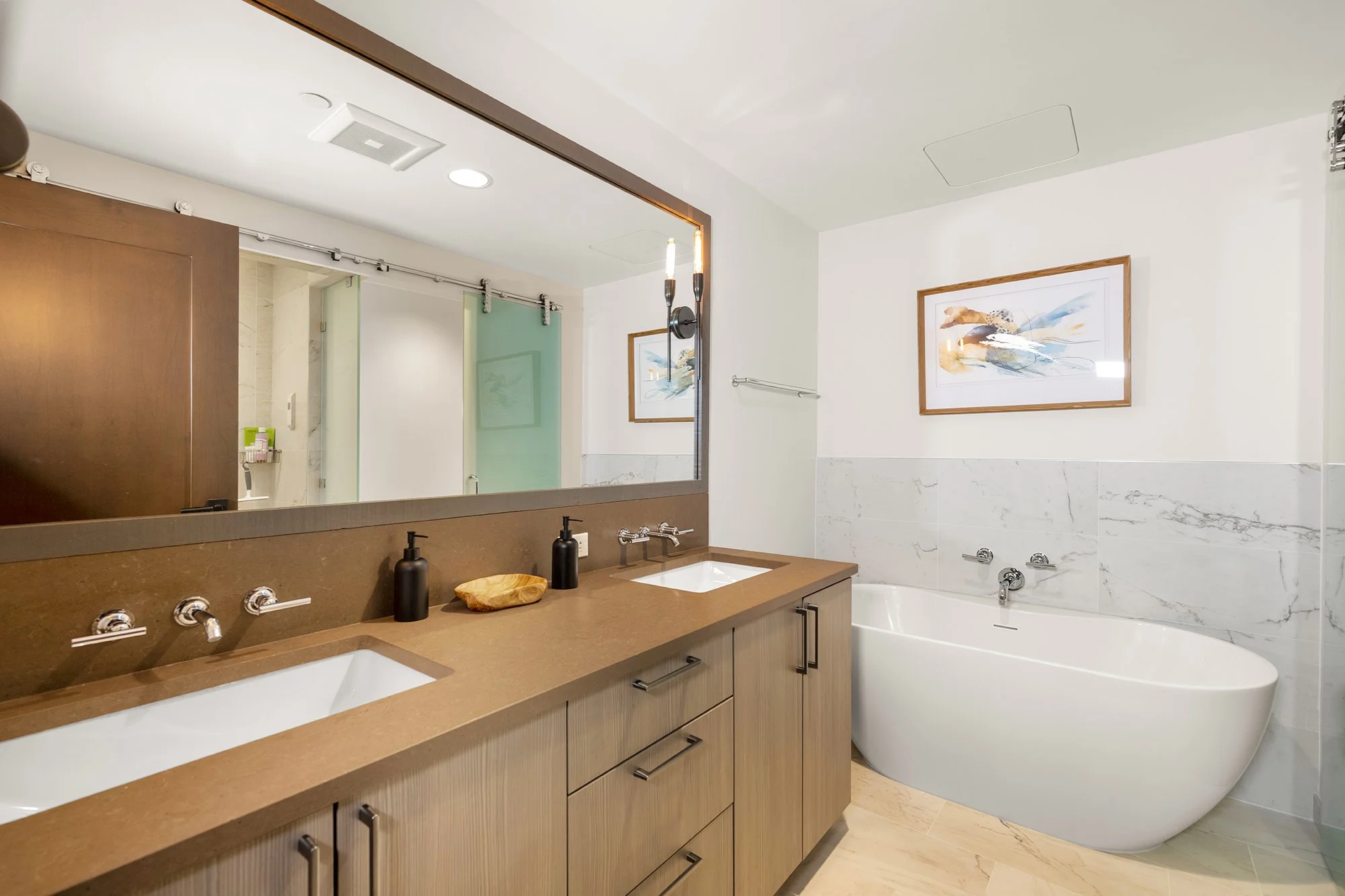 This luxurious bathroom features a large tub and double vanity.