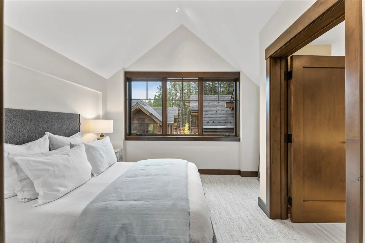 Spacious bedroom with contemporary furnishings, a comfortable king bed, ensuite bath and large windows creating a bright and inviting retreat.