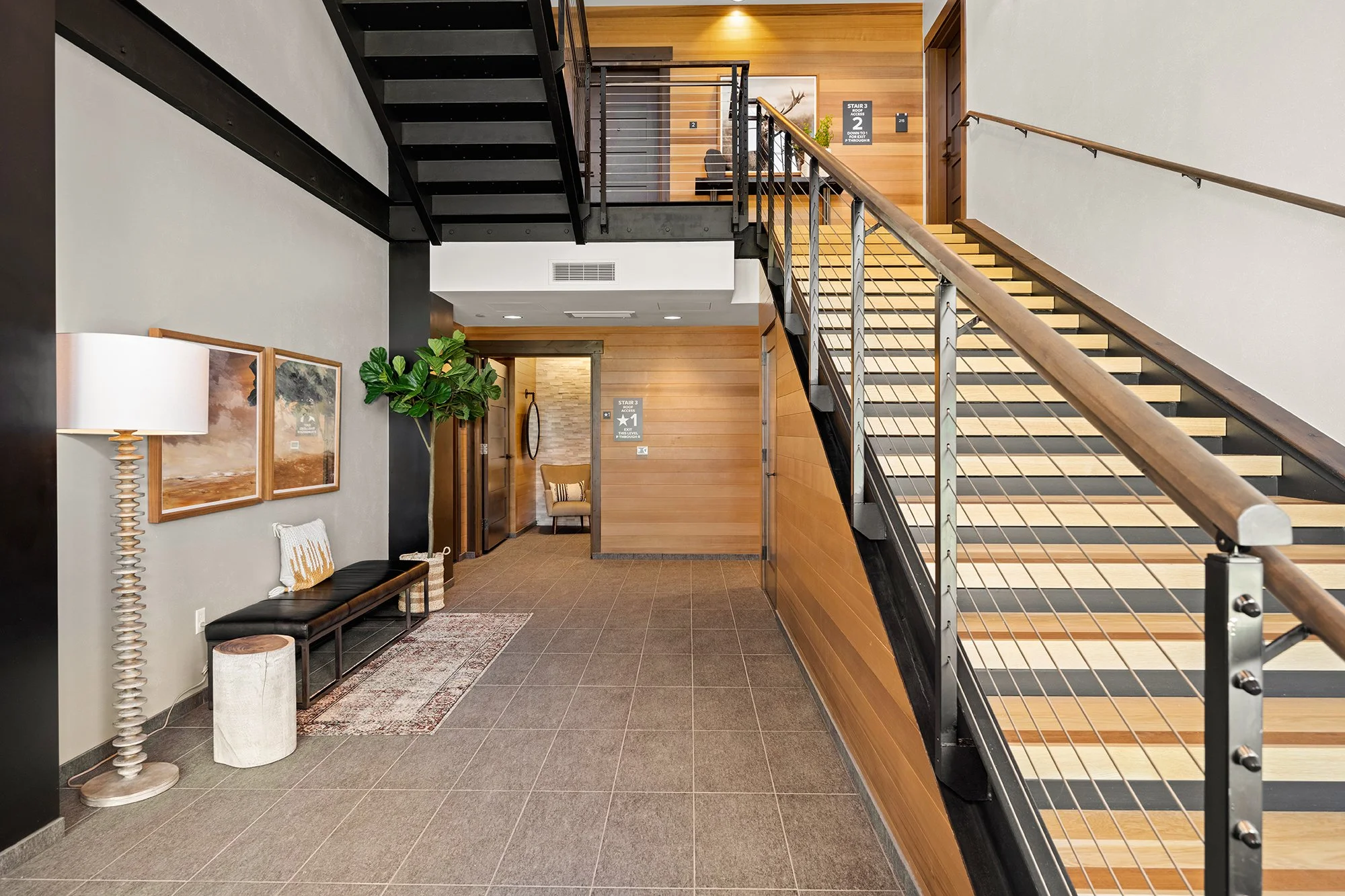 The Tahoe Beach Club entrance features a contemporary hallway with stairs and a wooden railing, adding a touch of elegance.