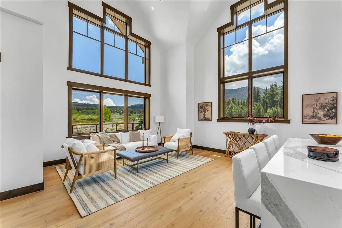 Sophisticated mountain-modern residence with an open-concept floor plan, dramatic ceilings, large scenic windows, and an upper loft that enhances the home’s spacious and inviting design.