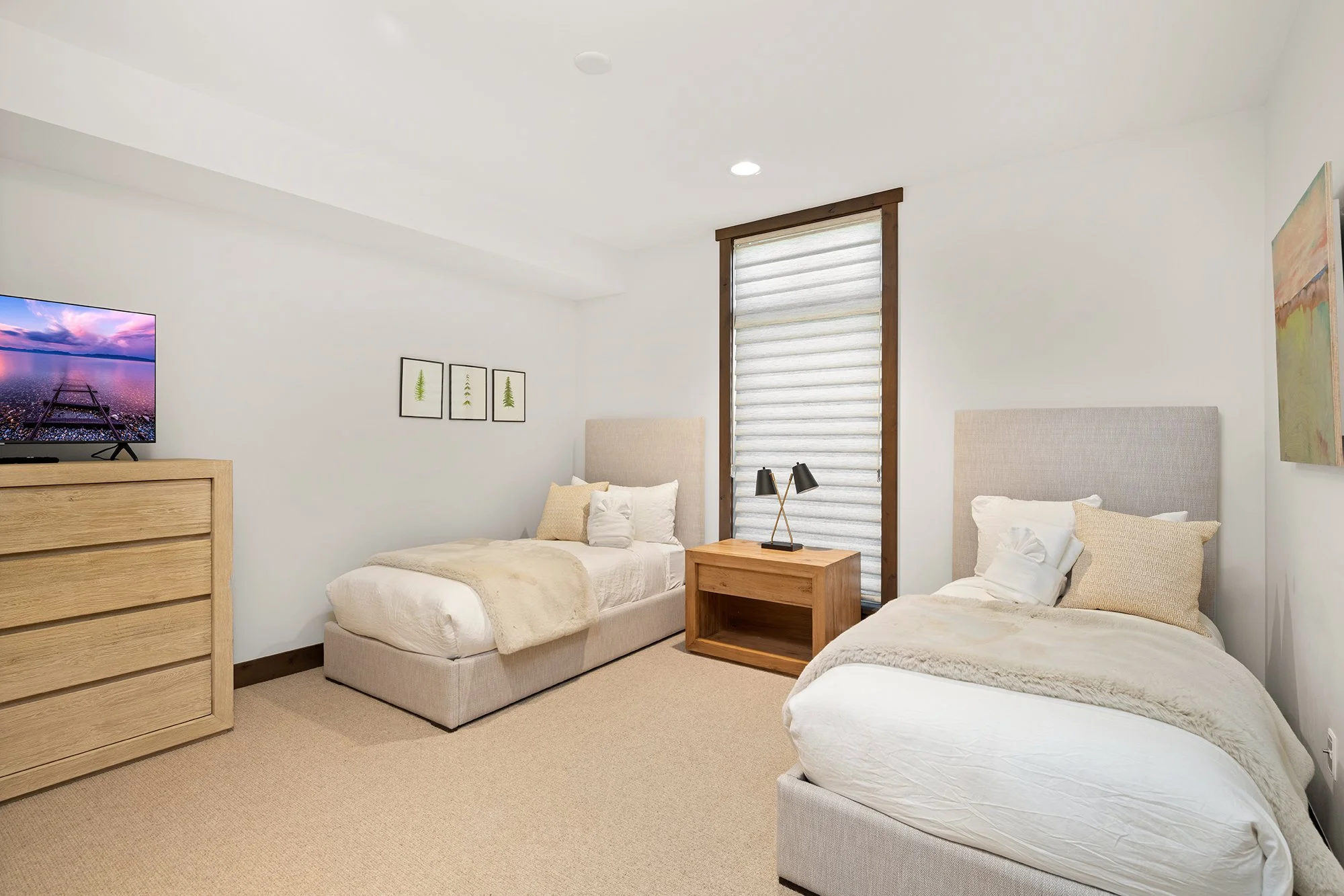 This vacation rental features a comfortable bedroom setup with two twin beds and a TV.