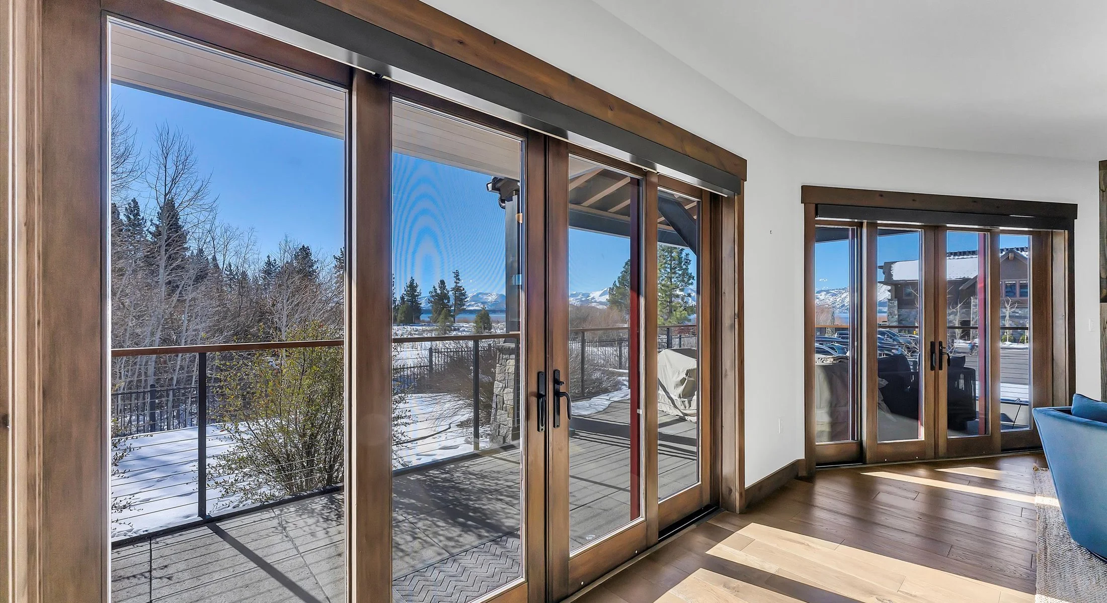 The living room features 2 large 4-panel glass doors leading out to a private patio while letting in an abundance of natural light.