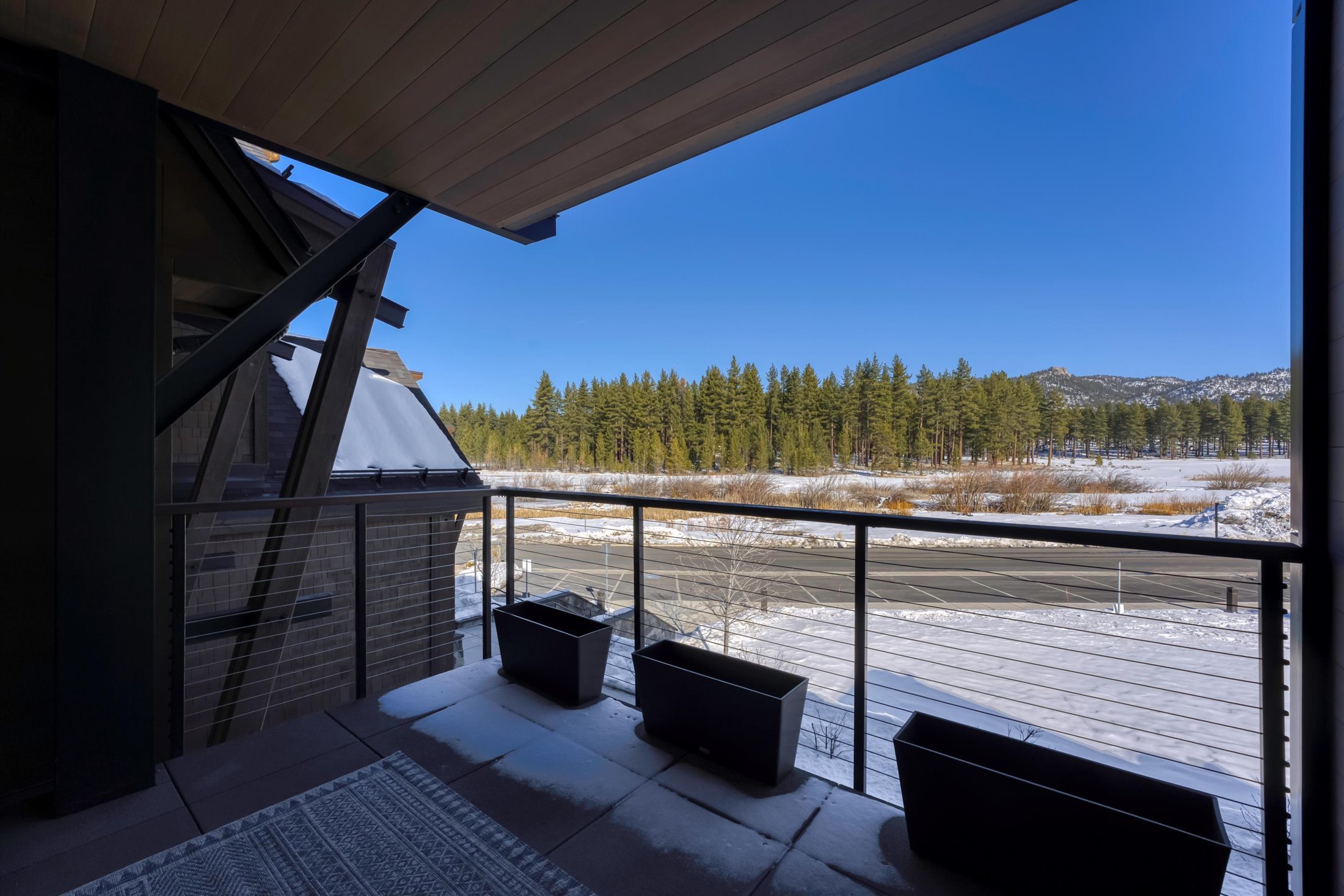 Private Tahoe Beach Club covered balcony with outdoor seating and stunning Tahoe views.
