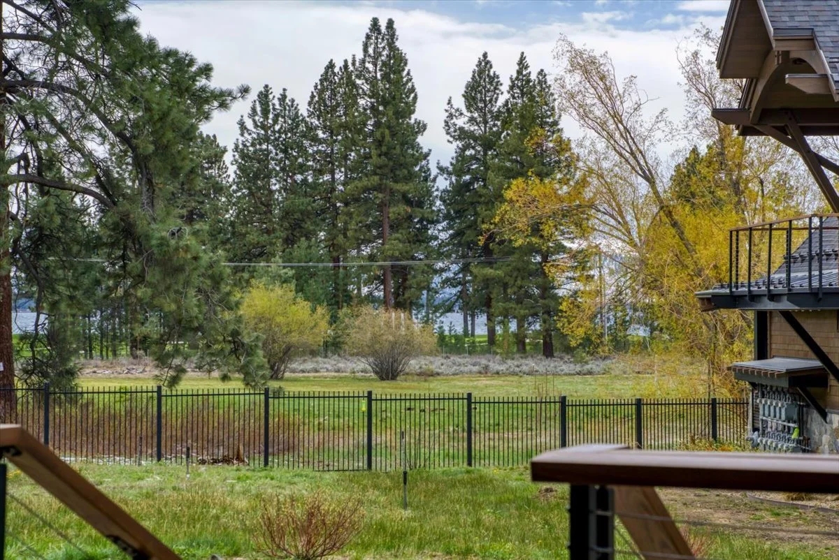 Private patio with stunning scenic views of the Tahoe meadow, surrounding forest, and a peek of Lake Tahoe, creating a peaceful outdoor space to relax and enjoy the natural beauty.