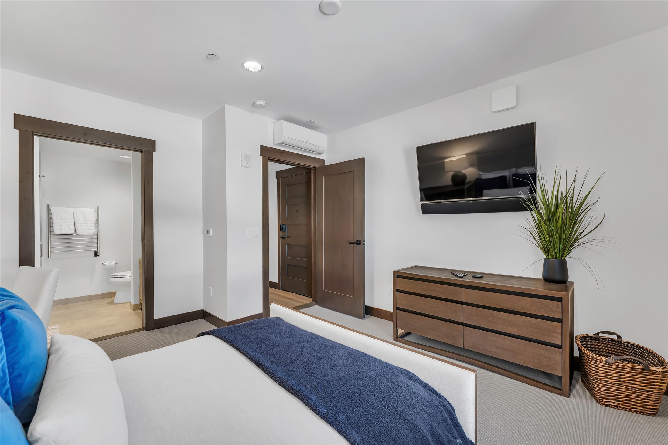 Bright Tahoe Beach Club bedroom featuring modern, cozy décor and an en-suite bathroom.