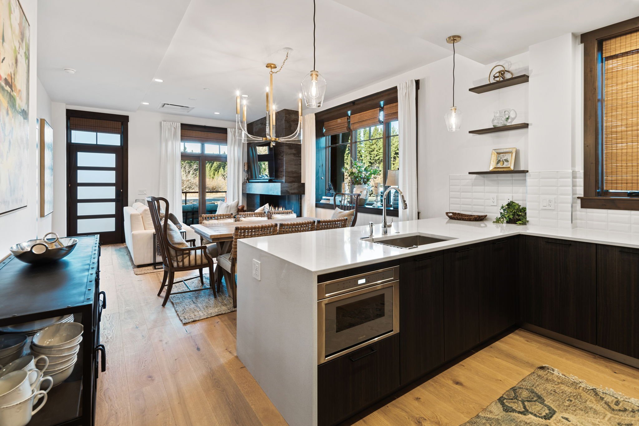 Bright open-concept floor plan featuring a kitchen, dining and living area with hardwood floors throughout.