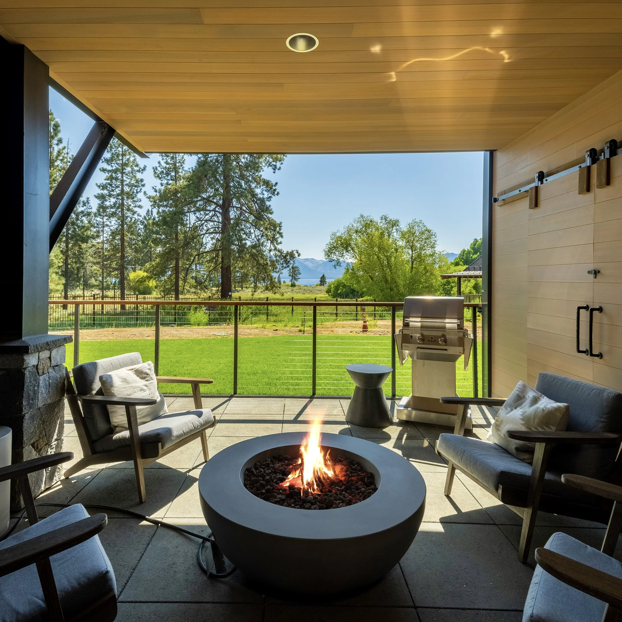 An outdoor patio featuring comfortable chairs arranged around a fire pit, offering a perfect spot to unwind and enjoy views of Lake Tahoe.