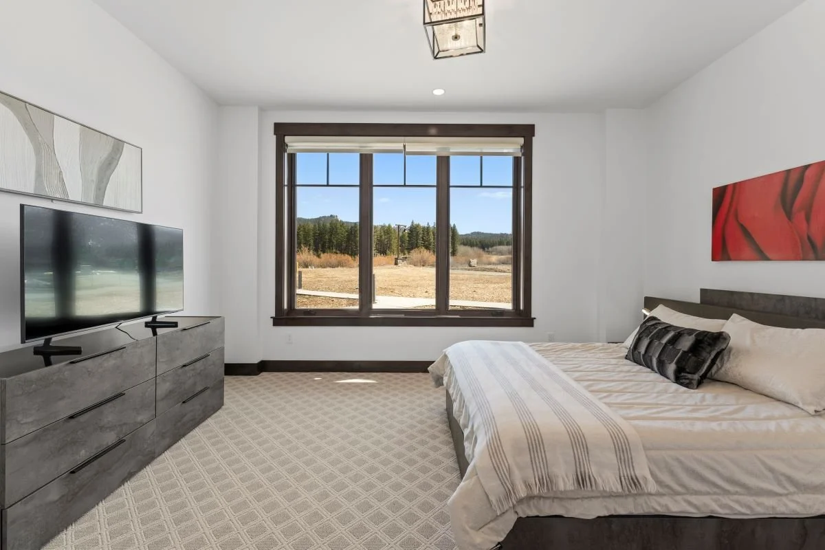 Bright and tranquil Tahoe Beach Club bedroom with forest and mountain views and en-suite bathroom 