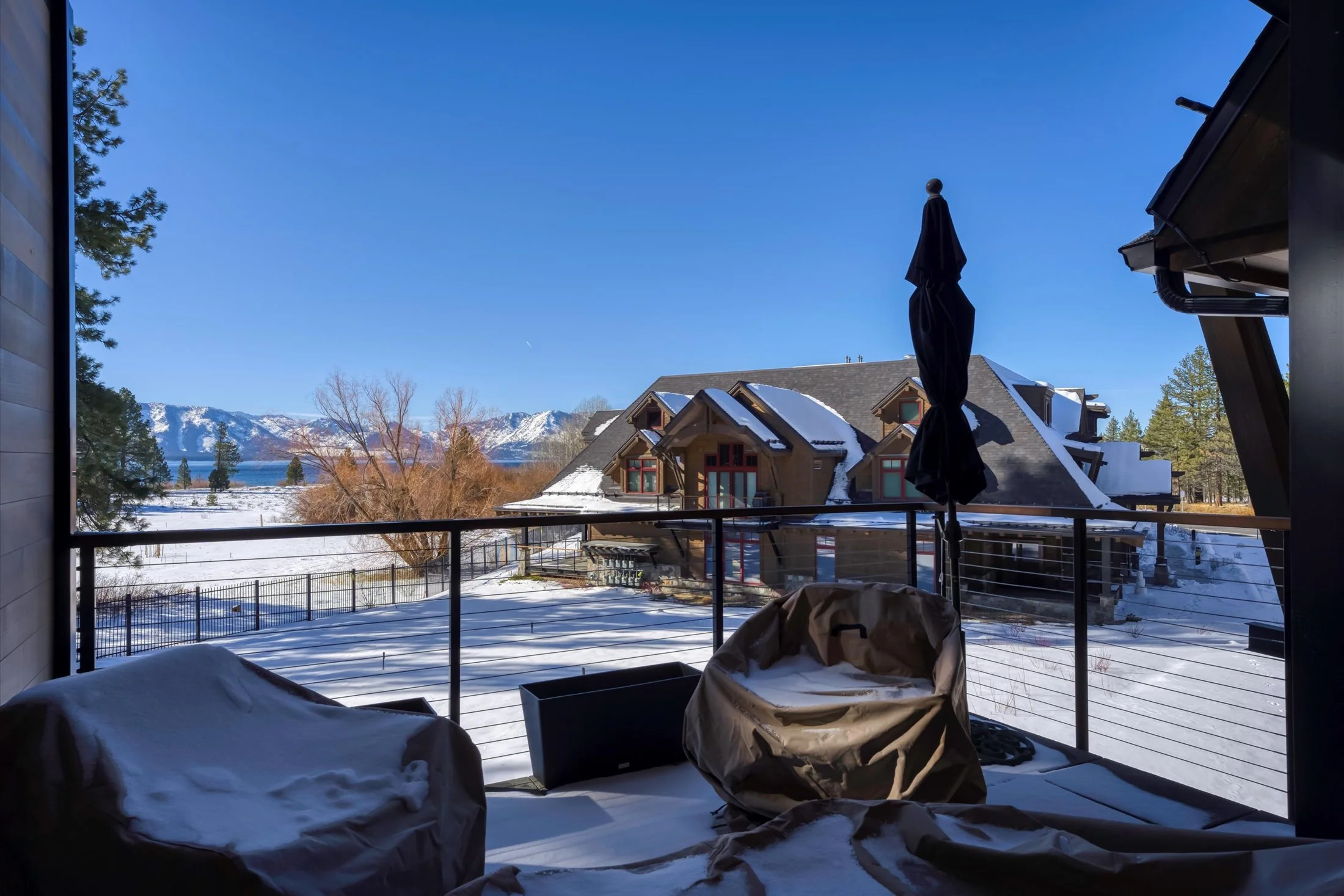 Private Tahoe Beach Club balcony with outdoor seating and stunning lake views.