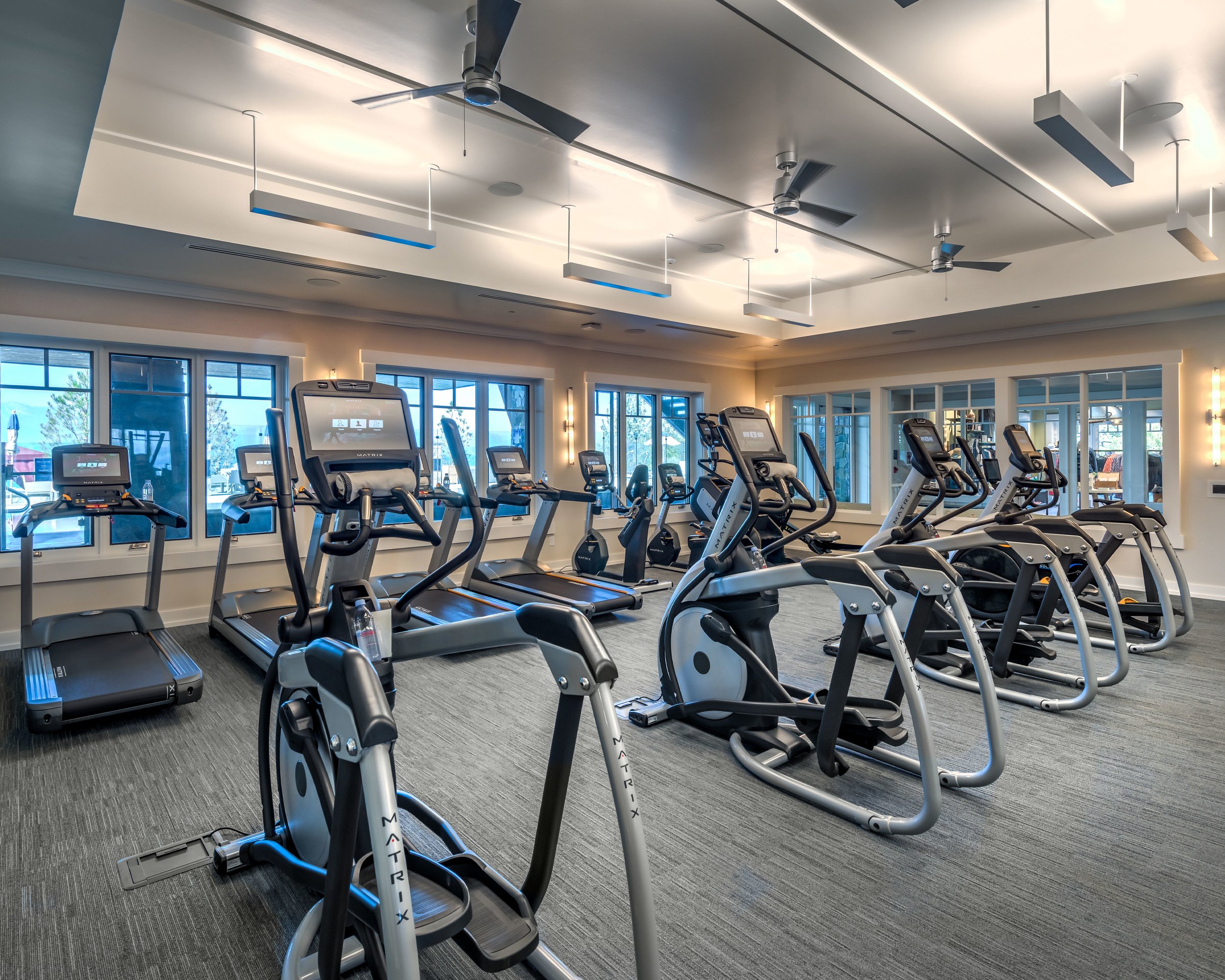 Modern fitness center featuring a variety of workout machines and ample space for exercise.