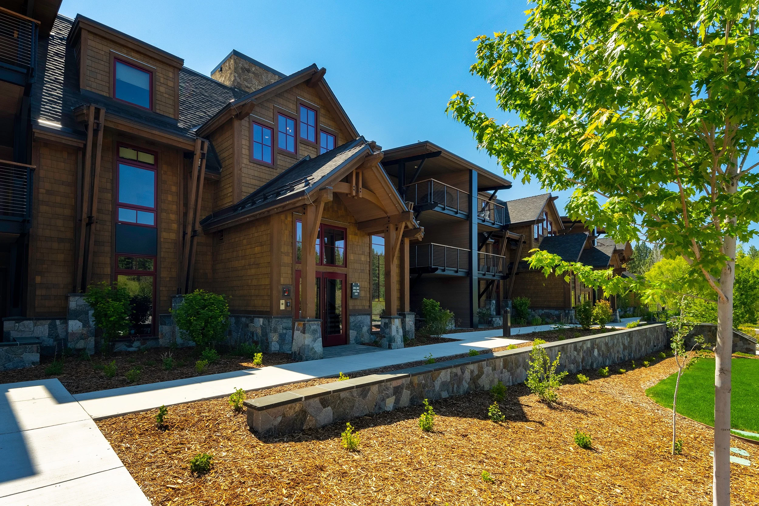 The scenic lodge exterior of Tahoe Beach Club, surrounded by lush greenery, offering a tranquil retreat in the heart of Tahoe.