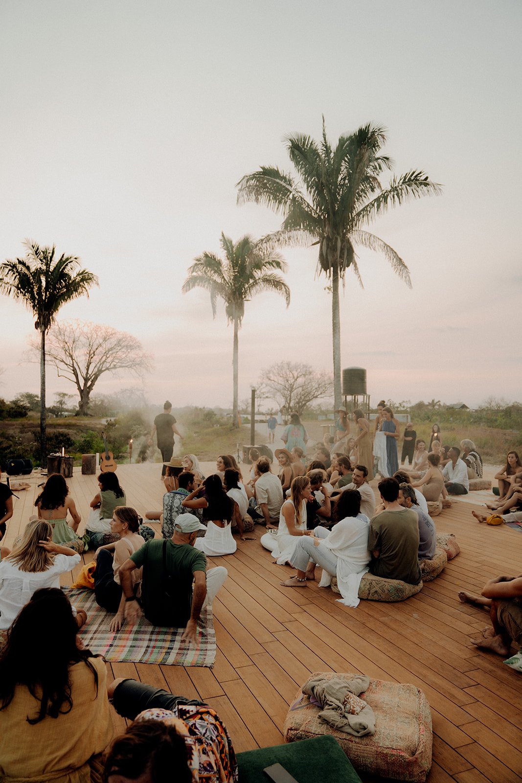 Evening concert at The ARK’s Yogashala with guests gathered in a candle-lit setting surrounded by nature.jpg
