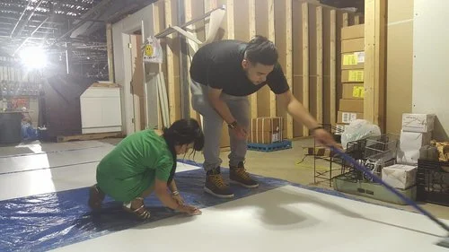 Left to Right: Kimberly and Tony. Duo team hard at work sanding down the board and cleaning off the board! (Photo: Kathy)