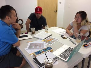 Left to right: Tam, Tony, and Kathy (Photo: Tran)  Artist's at work! In the moment, artist team were discussing how designs could improve!