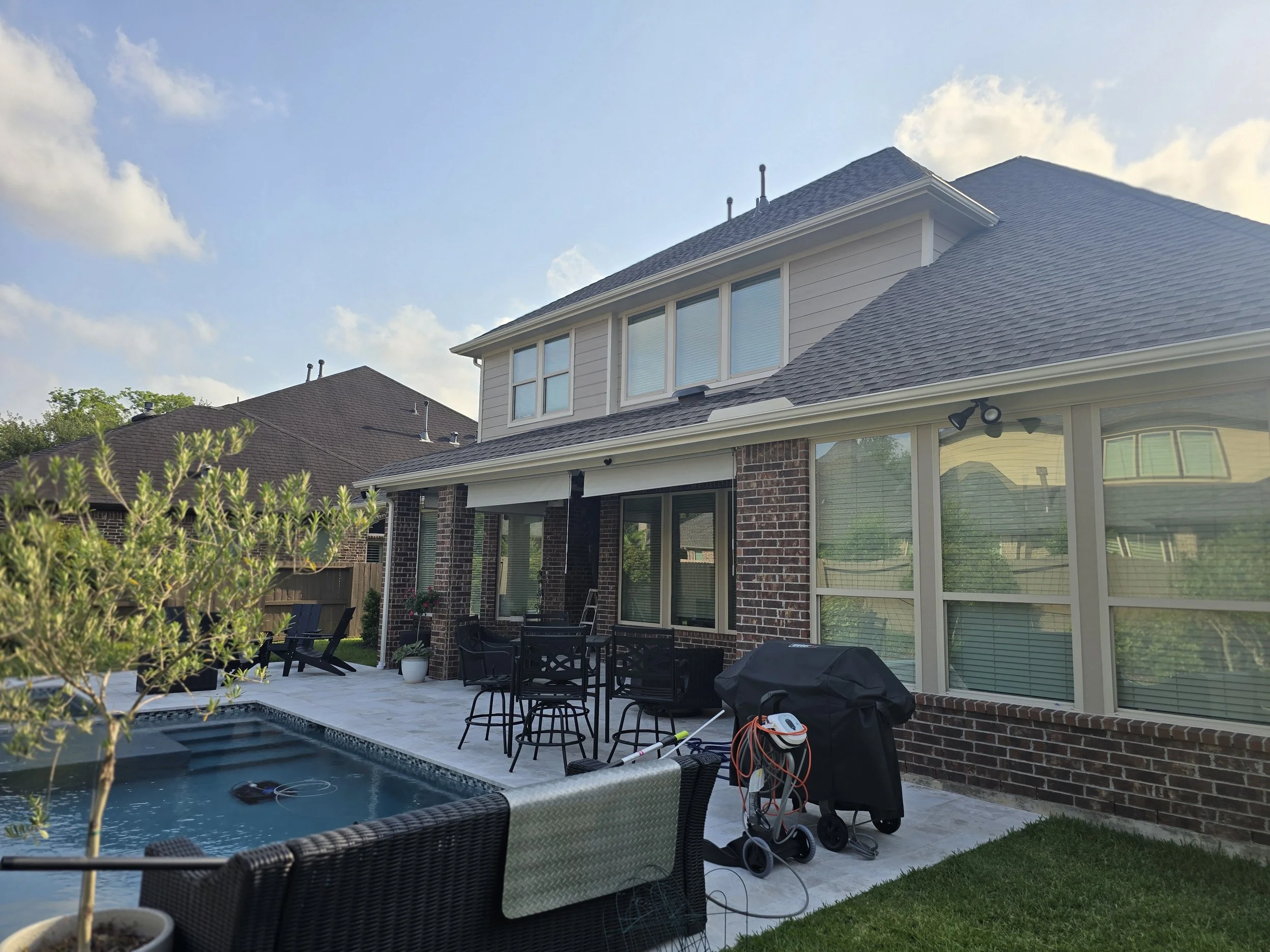 Exterior house painting project in Missouri City showing freshly painted siding and outdoor living area