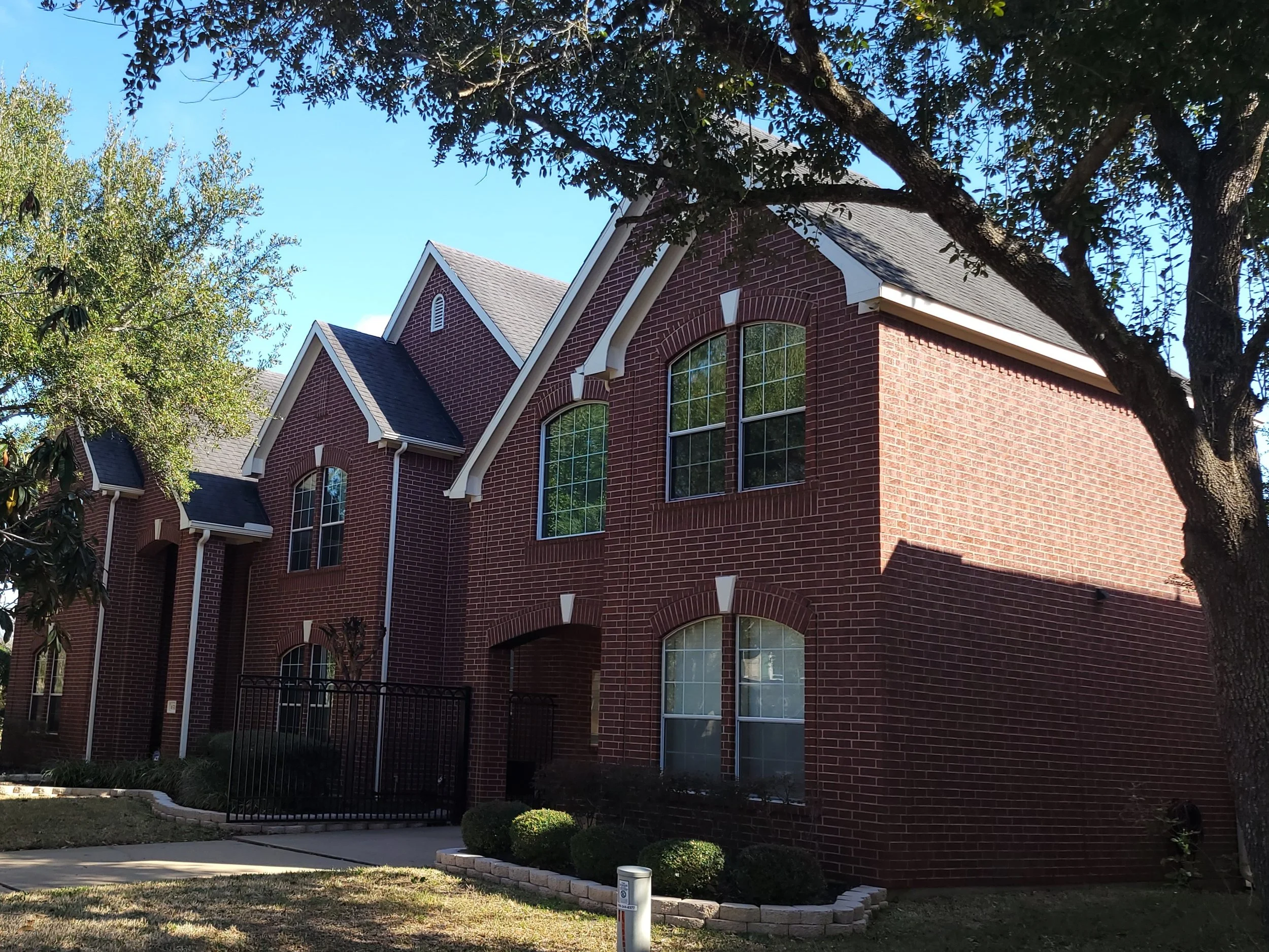 Exterior brick home prepared for professional house painting in Southwest Houston