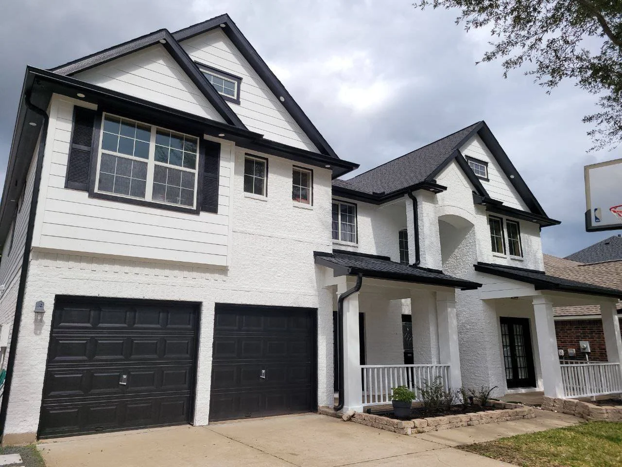 Freshly painted brick and hardy board house in white and black in Southwest Houston, Texas
